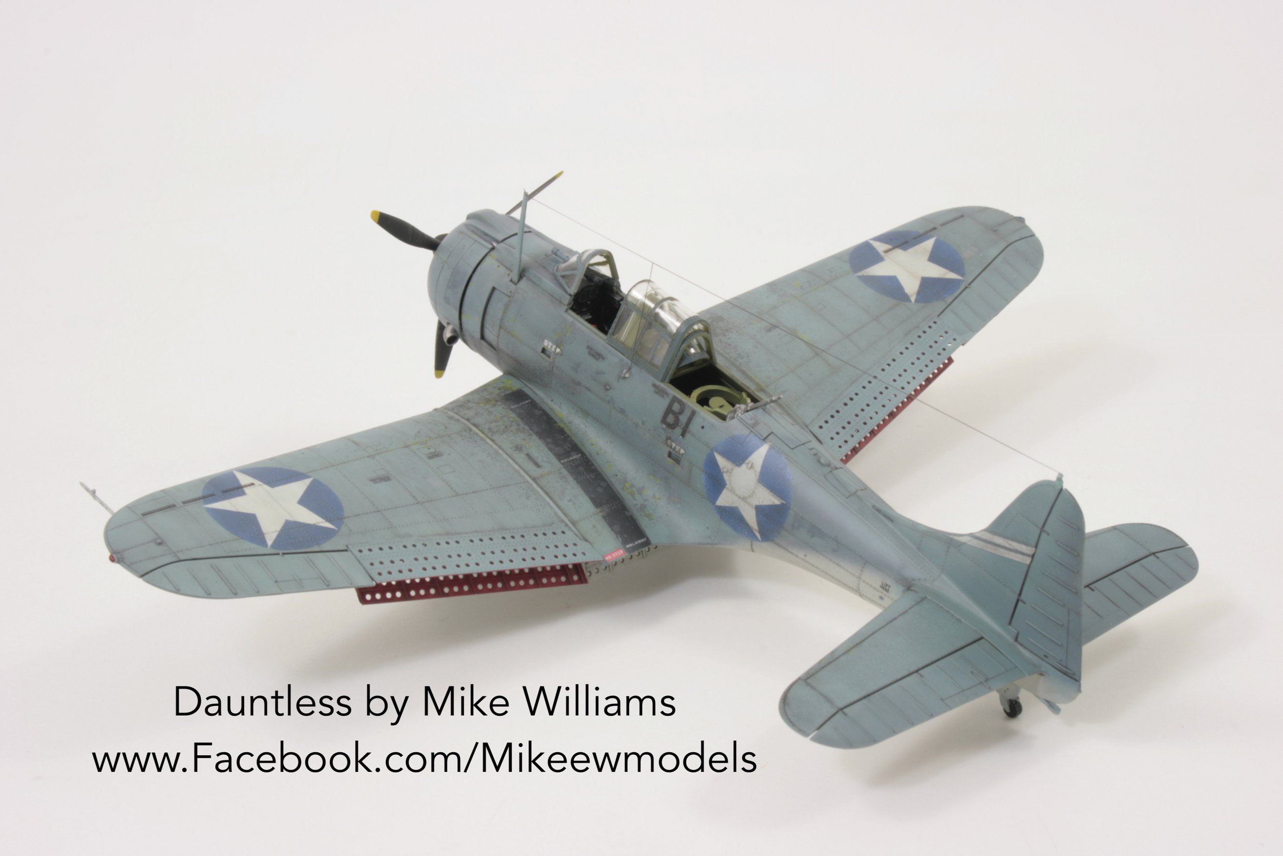 Model of a Dauntless aircraft by Mike Williams in gray with blue and white star insignia.