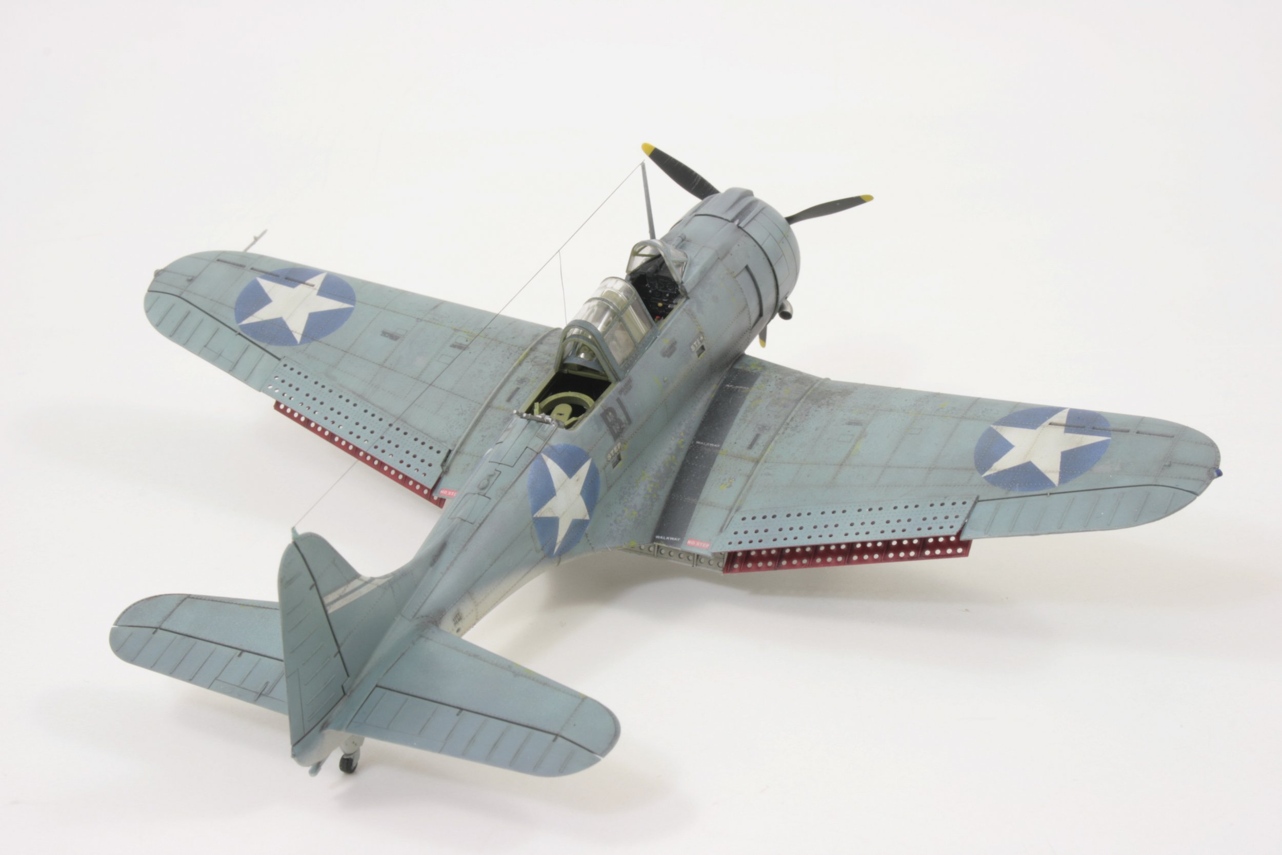 Model of a vintage military propeller aircraft from World War II with U.S. insignia.