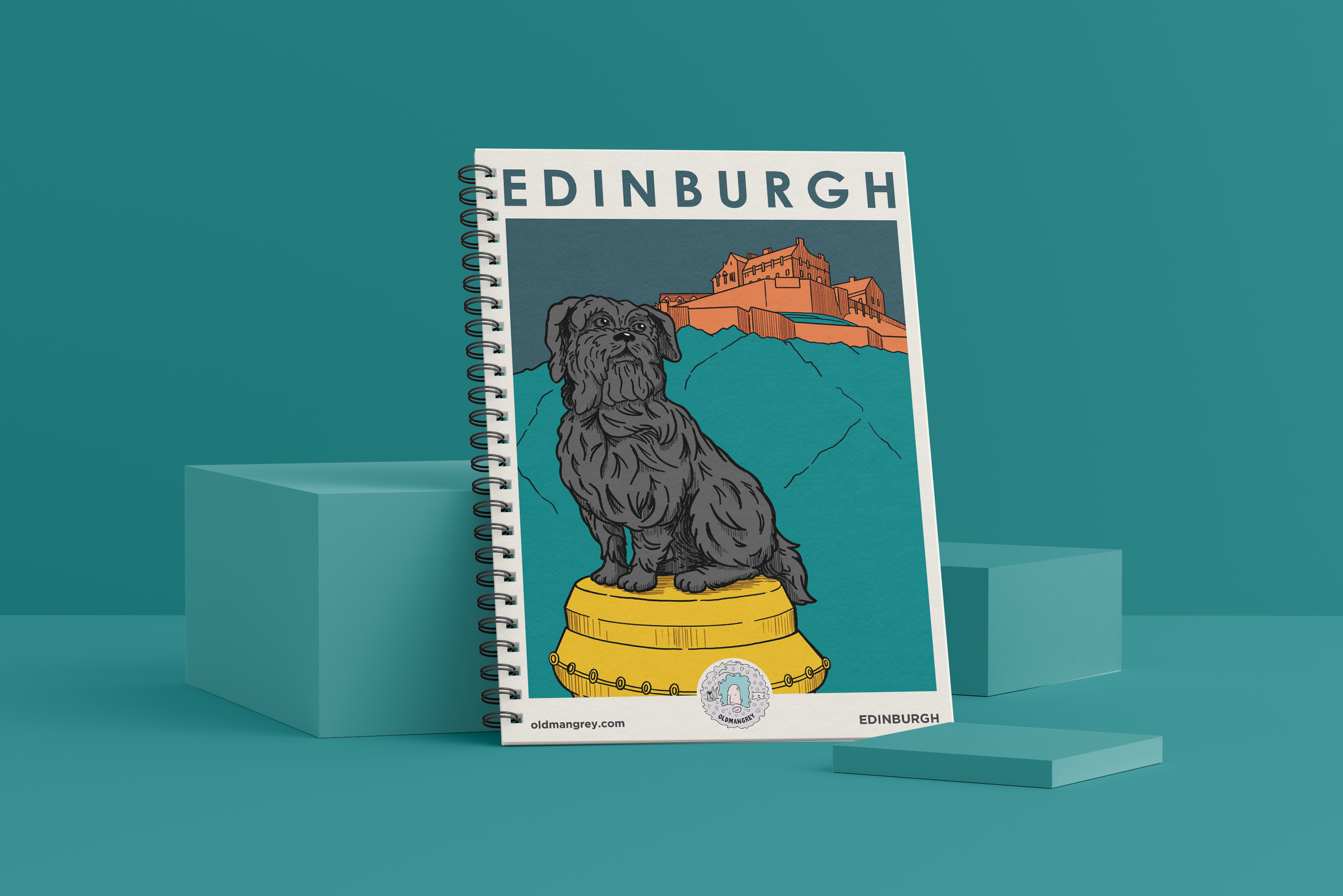My A5 Greyfriars Bobby wire bound notebook against a deep teal backdrop. It has a digital illustration of Greyfriars Bobby under the title 'Edinburgh'.