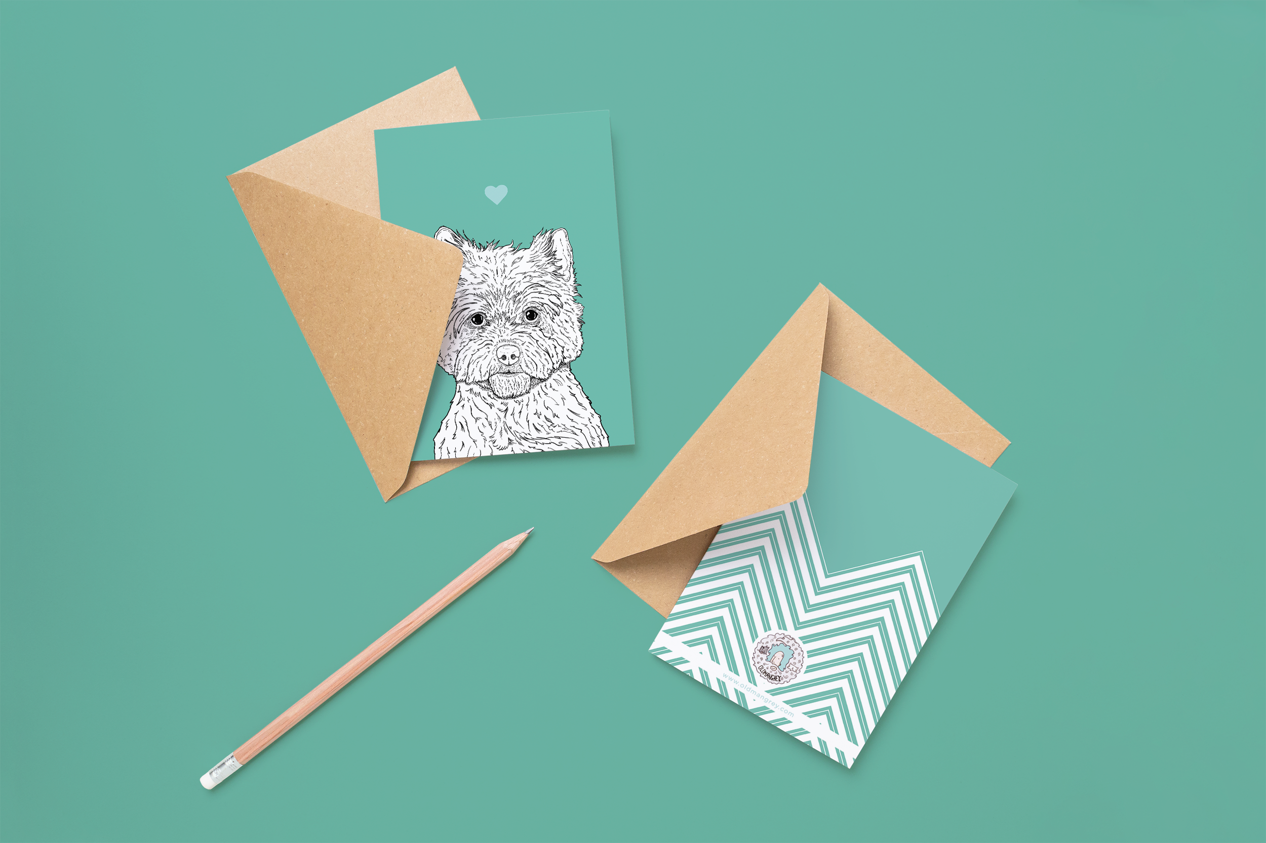 Two cards on brown envelopes, one face up one down. The card and image have a mint green coloured background, with a black & white digital illustration of the head & shoulders of a Cairn Terrier dog.