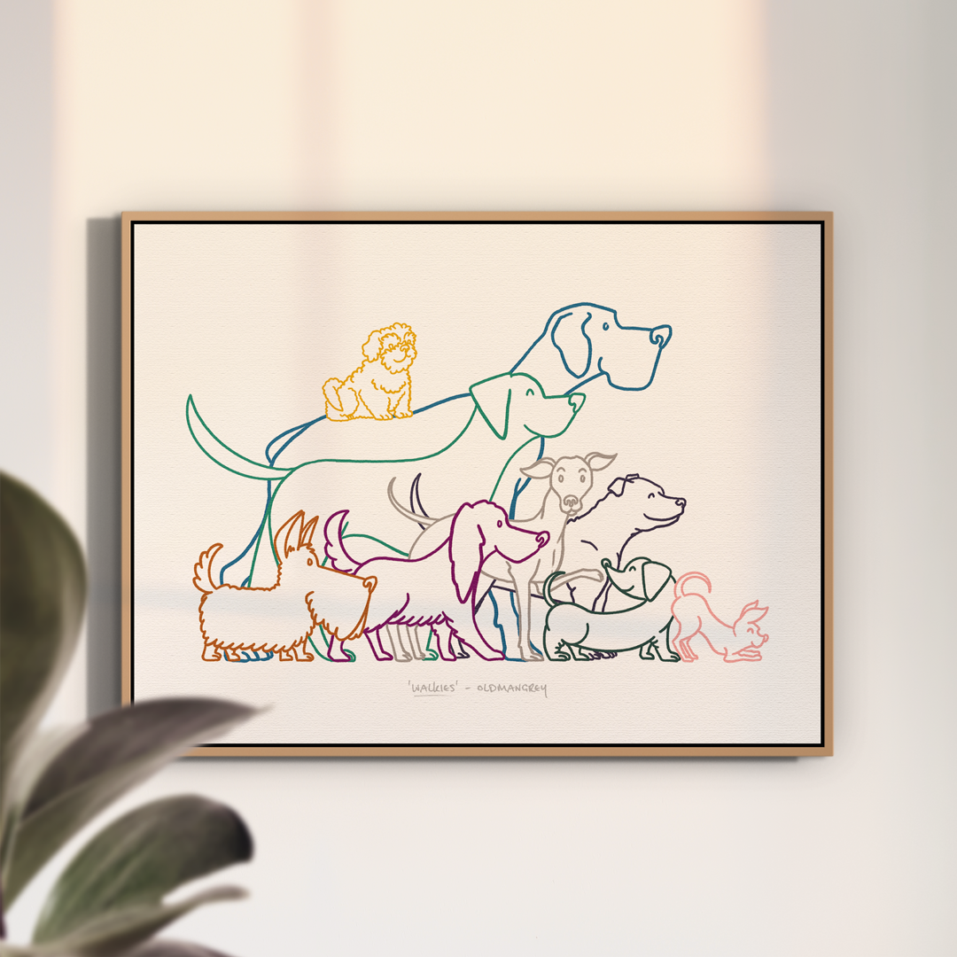 An A3 print in a thin wooden frame on a white wall with soft light. The print has a colourful digital illustration of 9 dogs all ready to go walkies!