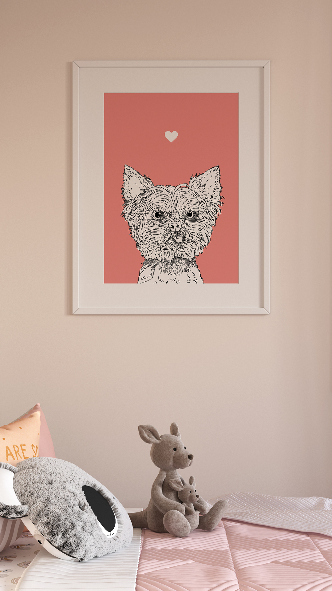 An A4 print in a white frame on a wall above a cushion & toy. It has a black & white illustration of the head & shoulders of a Yorkie Terrier dog on a pink background.