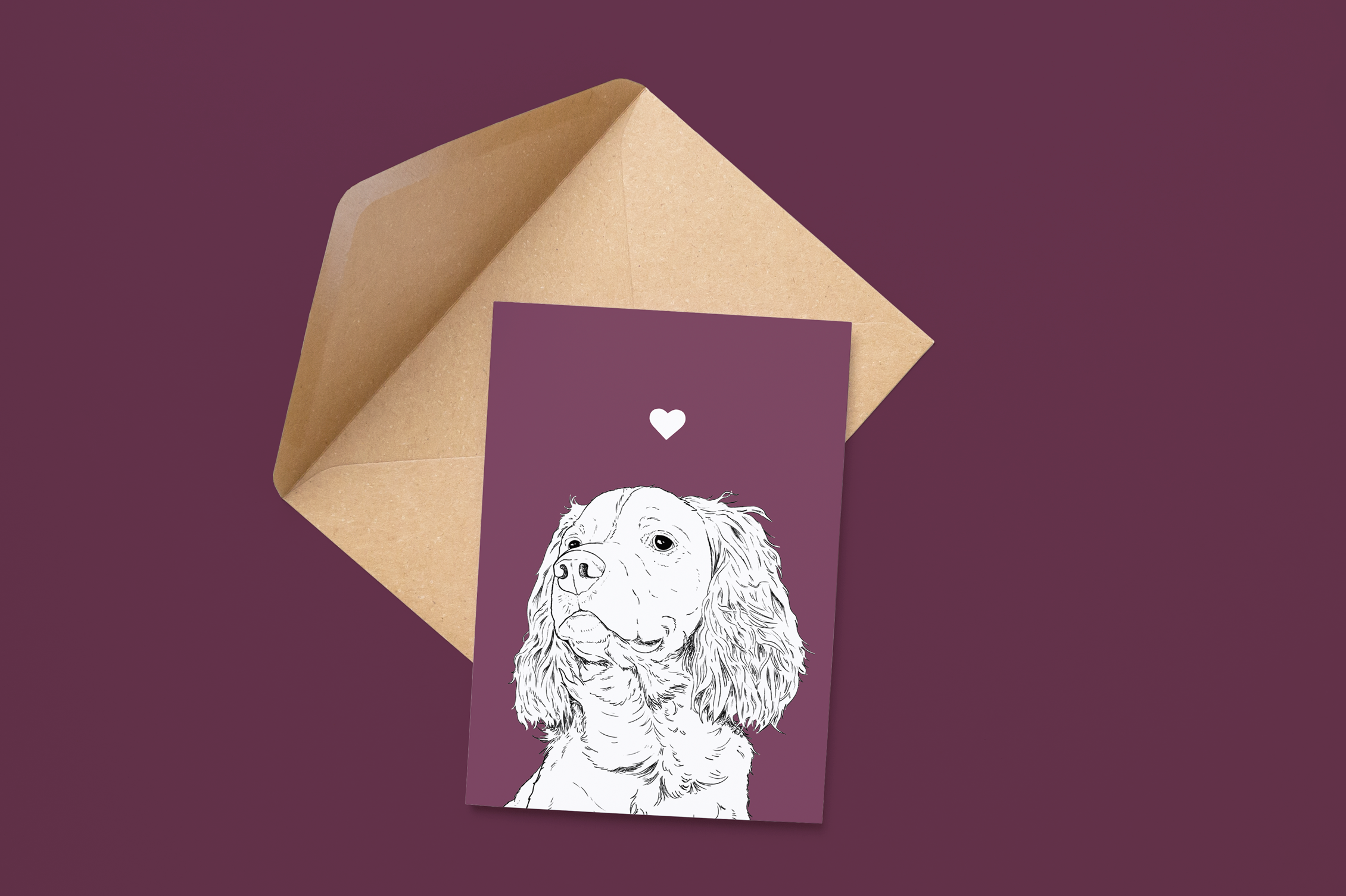 An A6 greetings card on a brown envelope. The card & image have a purple background, with a black & white digital illustration of the head & shoulders of a Springer Spaniel dog.