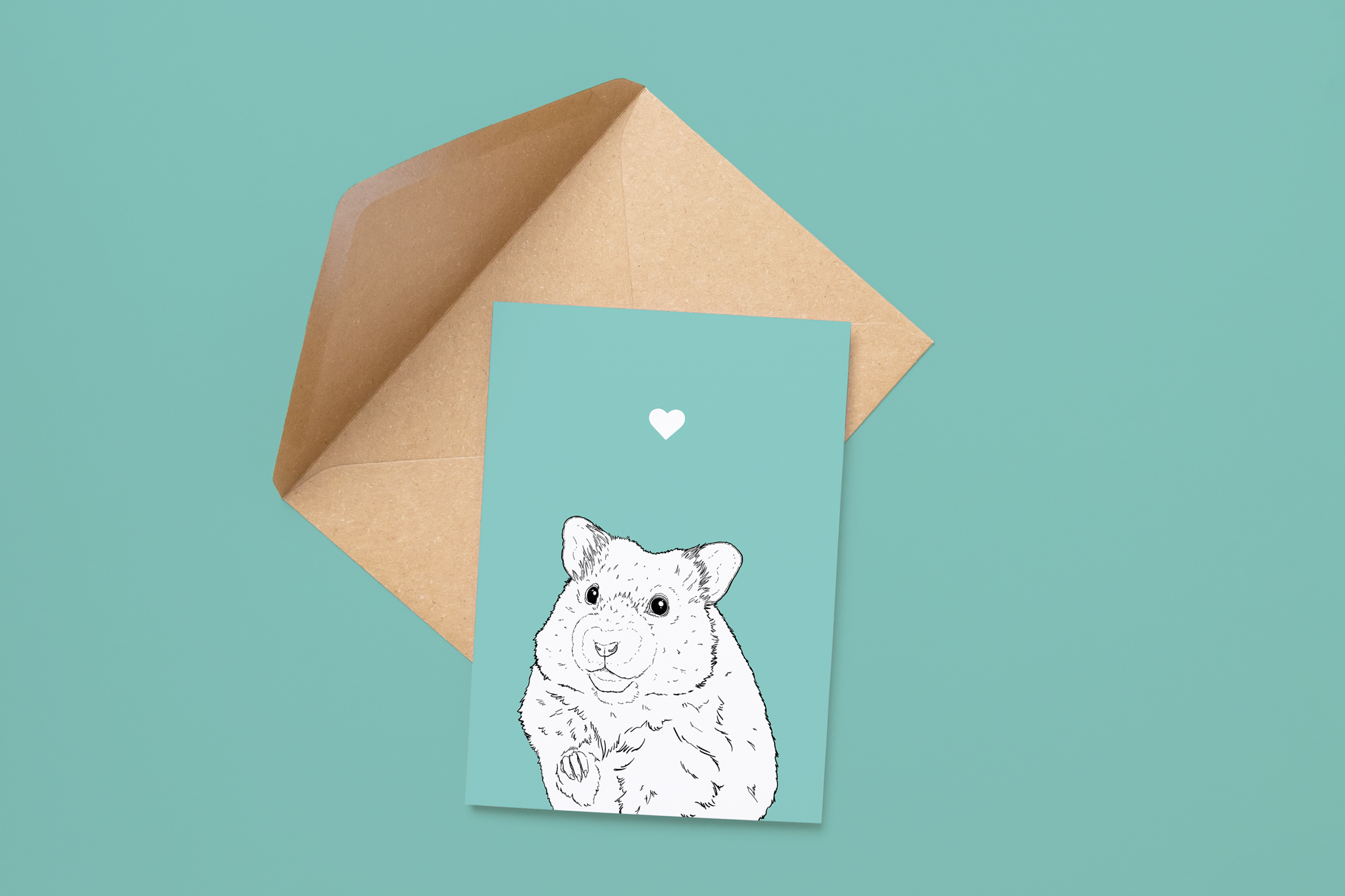 An A6 greetings card on a brown envelope. The card & image have a pale blue background, with a black & white digital illustration of the head & shoulders of a Hamster.