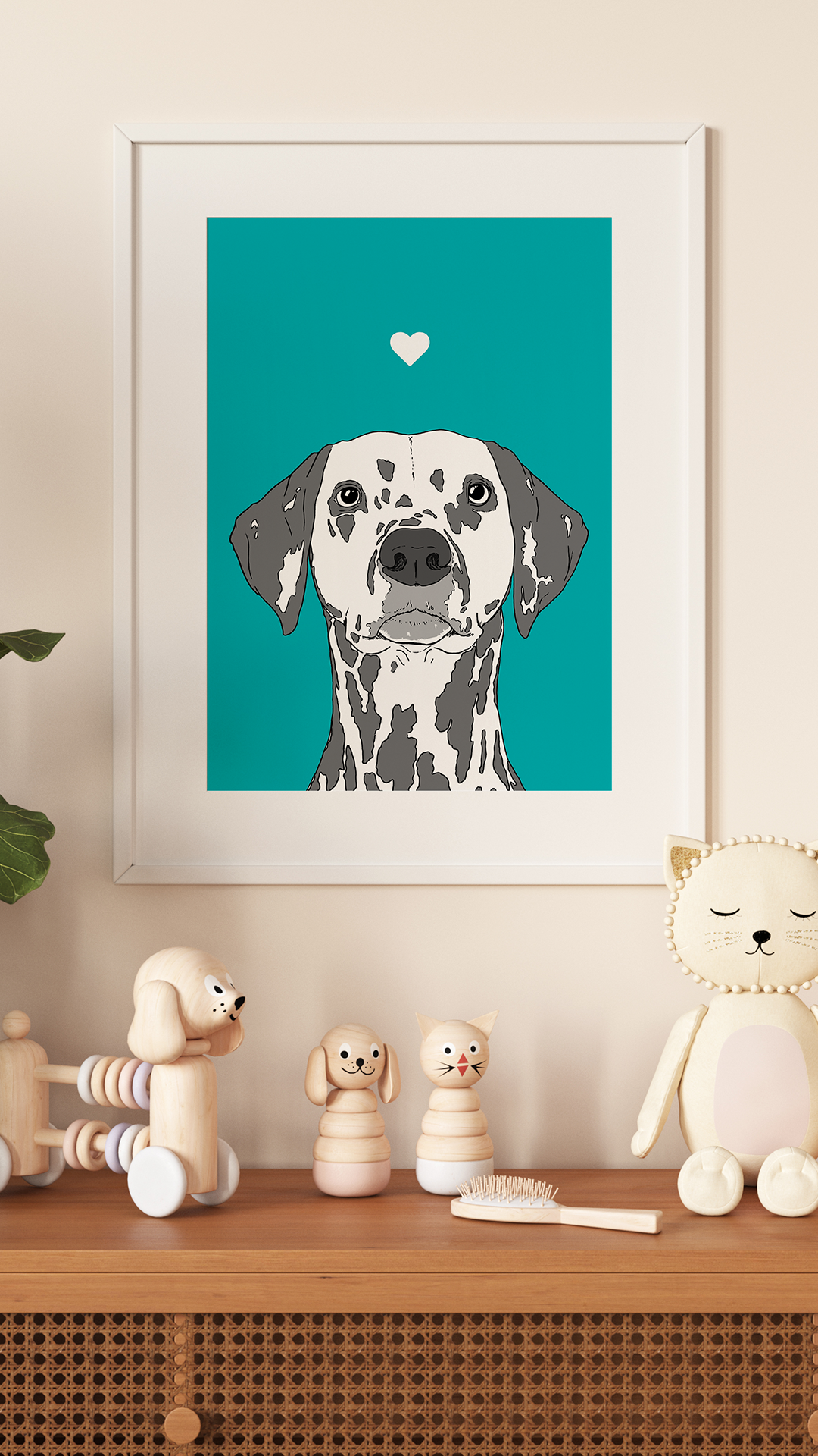 An A4 print in a white frame on a wall above pale coloured kids toys. It has a black & white image of the head & shoulders of a Dalmatian dog on a turquoise background.
