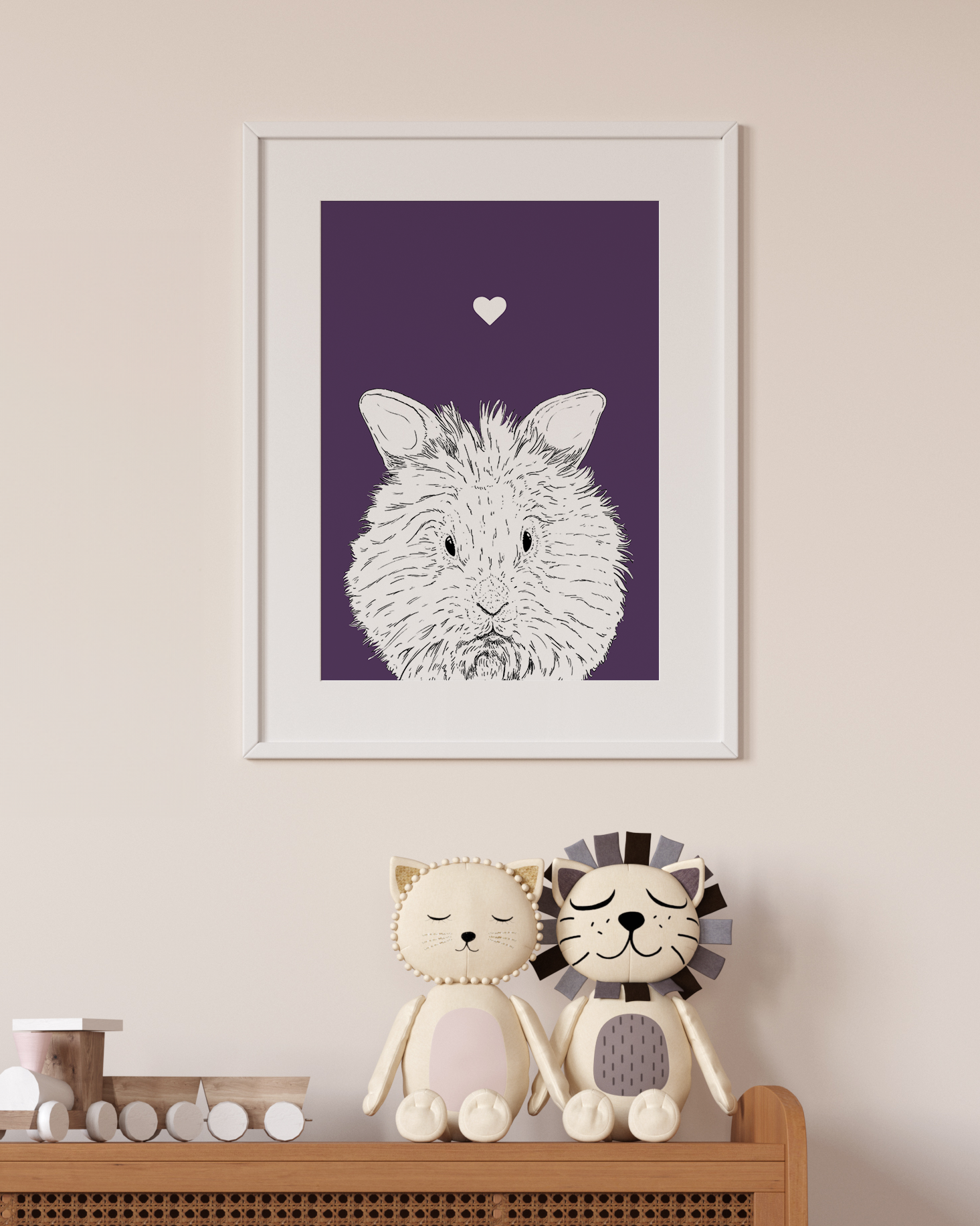 An A4 print in a white frame on a wall above 2 lion toys sitting on a unit. It has a black & white illustration of a Lionhead Rabbit on a purple background.