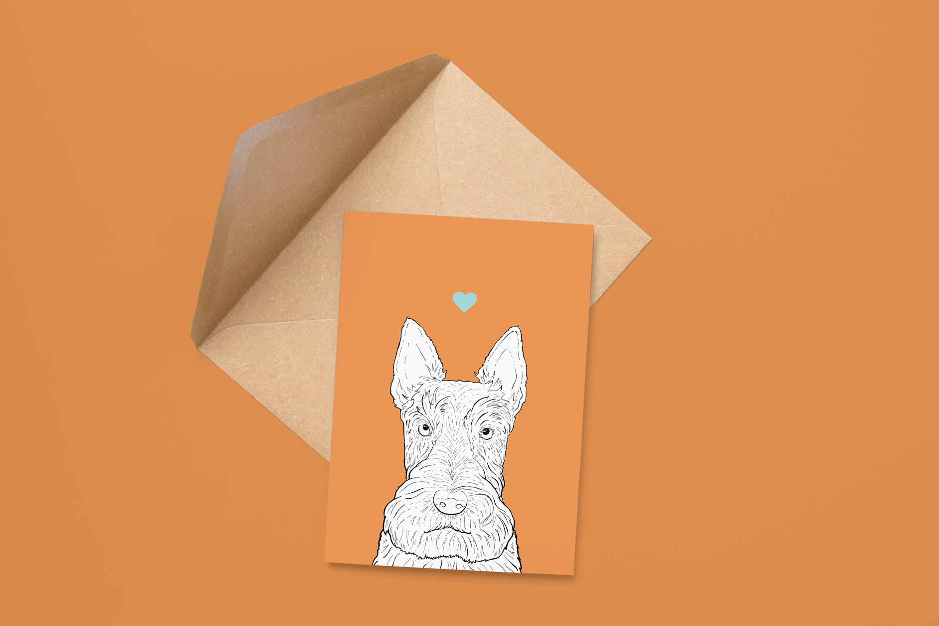 An A6 greetings card on a brown envelope. The card & image have an orange background, with a black & white digital illustration of the head & shoulders of a Scottie dog.