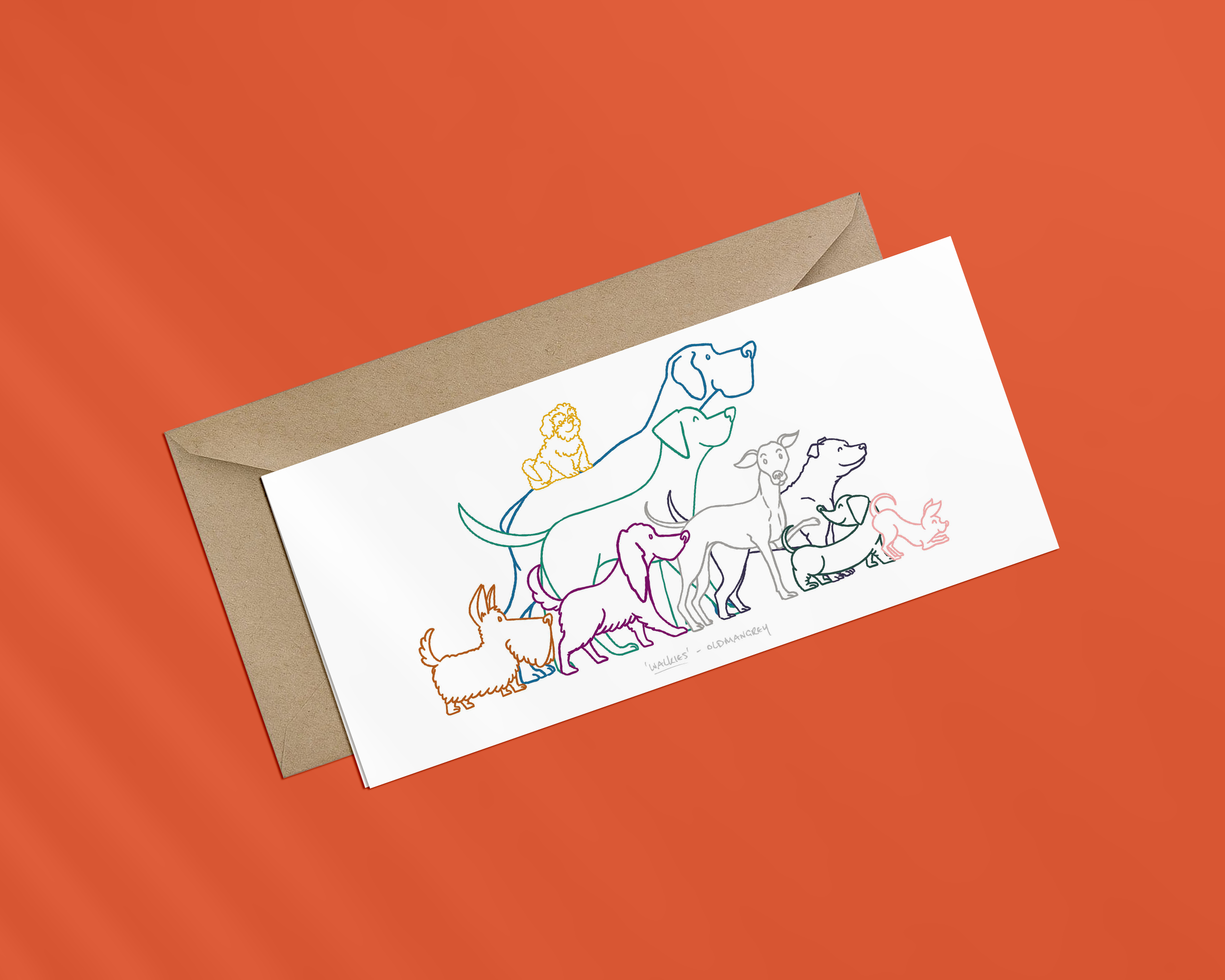 A landscape greetings card on a brown envelope, with a colourful digital illustration of 9 dogs eager to go walkies. The image has a warm red background.