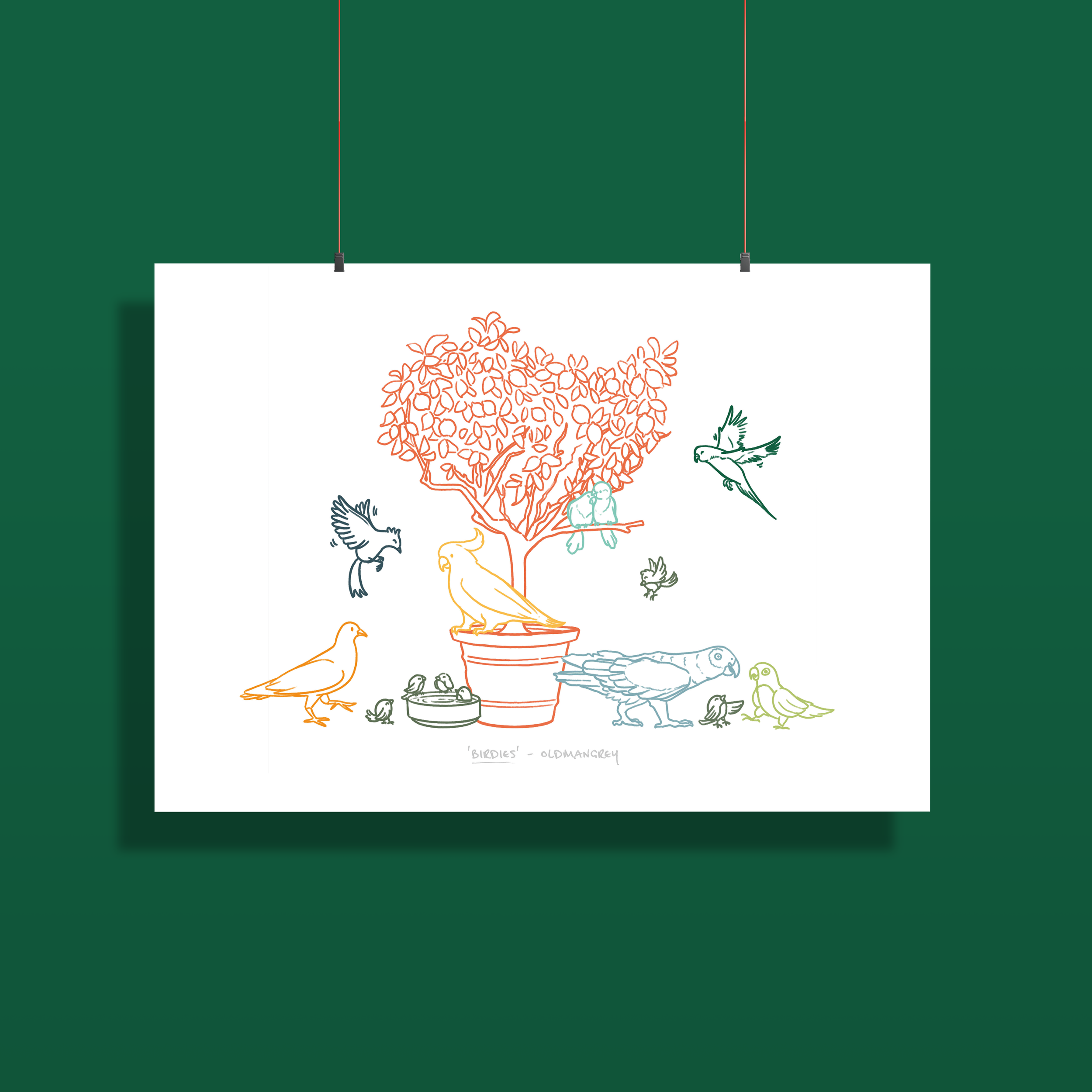 An A3 print set against a dark green backdrop, hanging by two thin strings clipped to the top edge. The print has a colourful digital illustration of birds on & around a small tree.