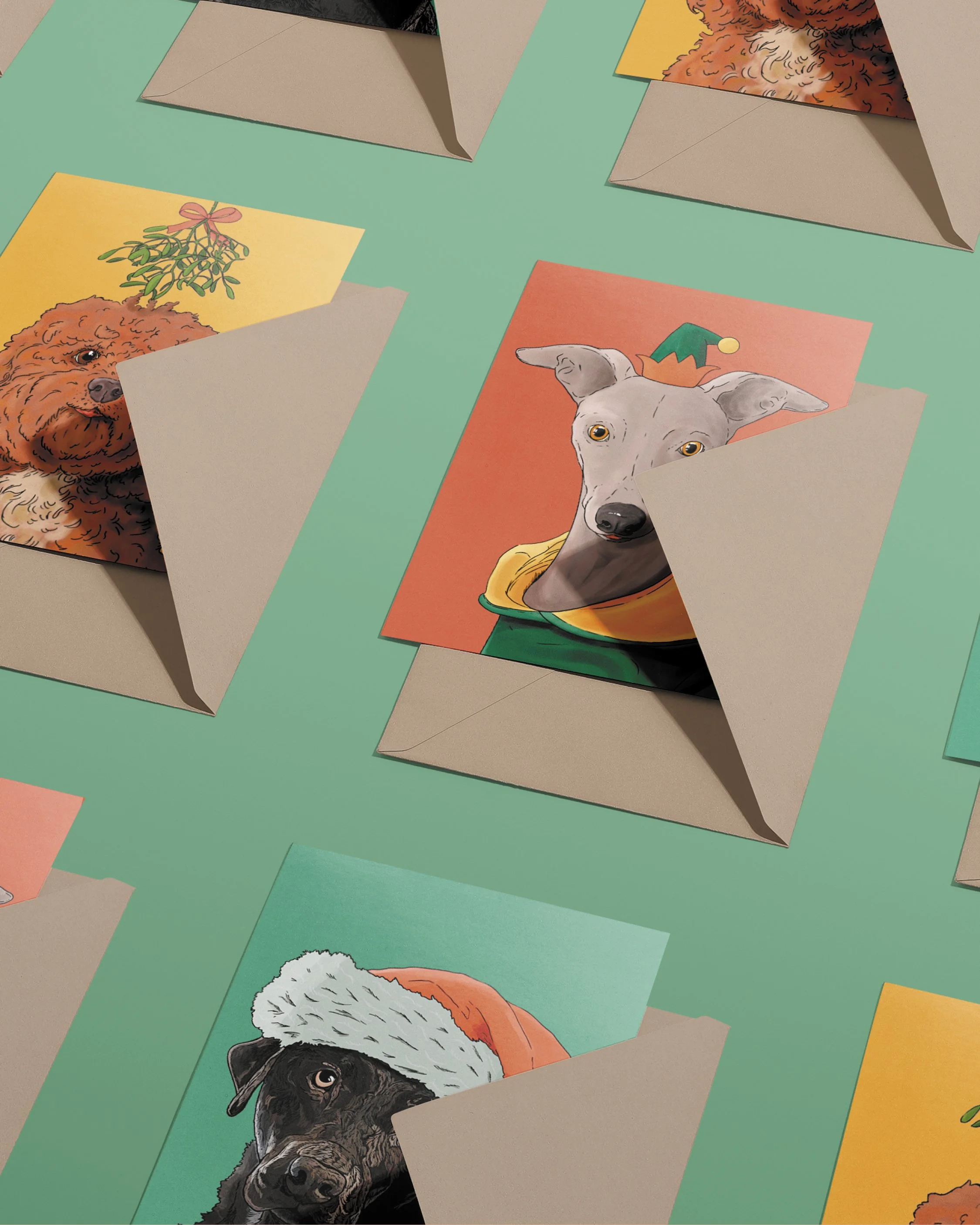 3 x A6 Dog Christmas Cards, bright digital illustrations including a Whippet in a green & red elf hat! Copies tucked into brown envelopes, set on a flat turquoise background.