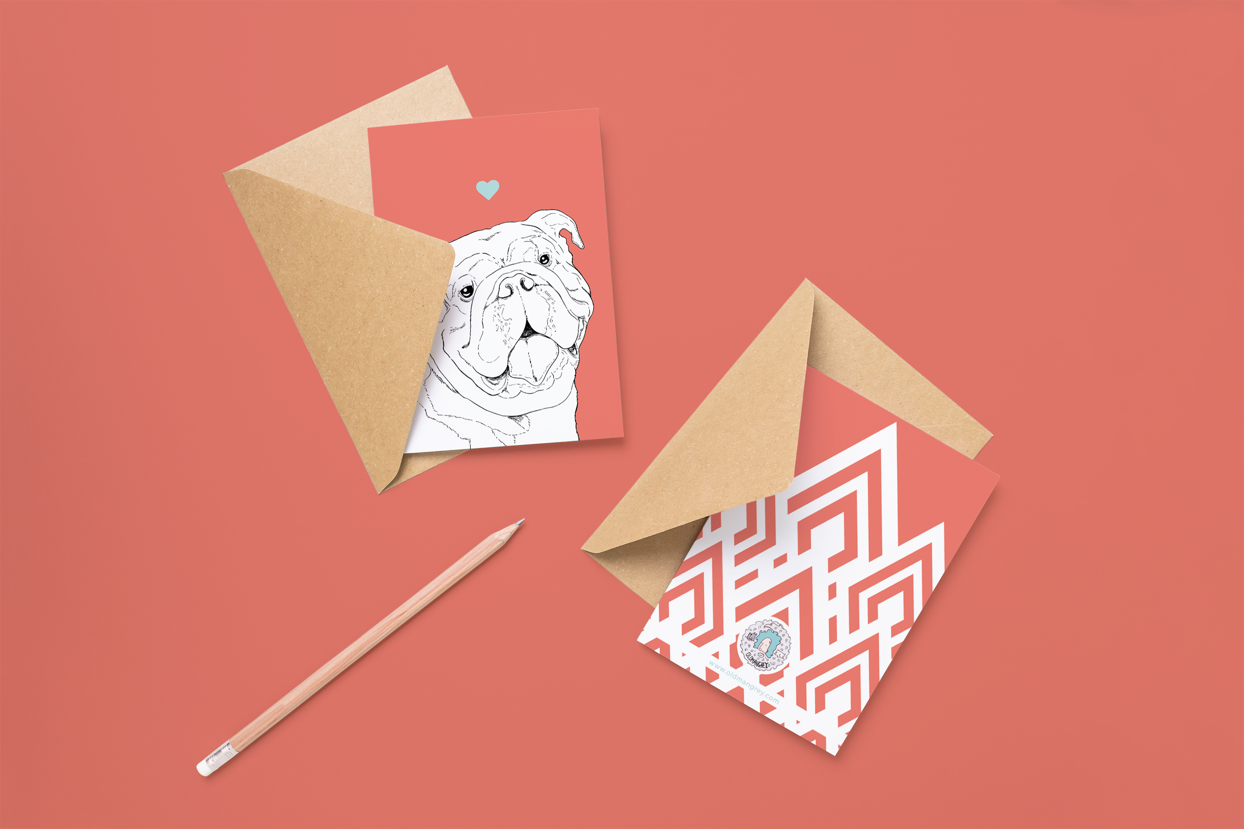 Two cards on brown envelopes, one face up one down. The card and image have a bright red coloured background, with a black & white digital illustration of the head & shoulders of a Bulldog dog.