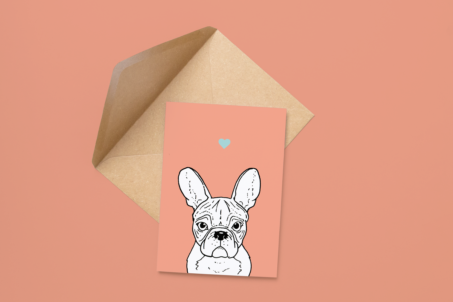 An A6 greetings card on a brown envelope. The card & image have a pink background, with a black & white digital illustration of the head & shoulders of a Frenchie dog.