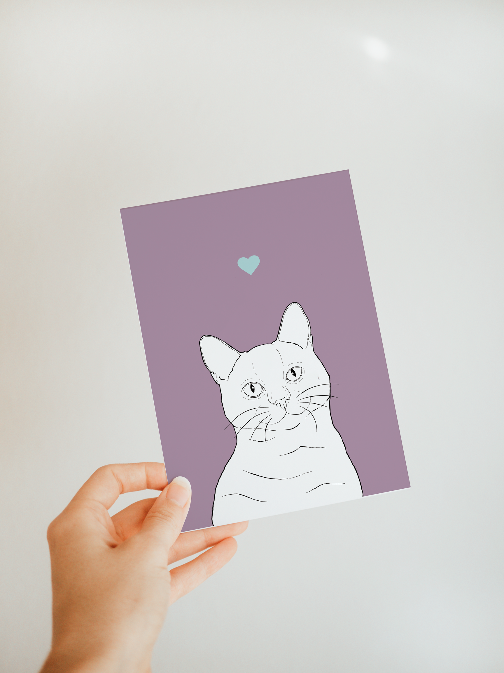 An A6 greetings card on a white background. It has a lilac purple background & black & white digital illustration of the head & shoulders of a Shorthair cat.