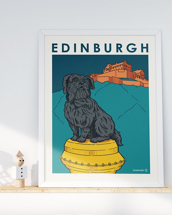 A4 digital illustration of Greyfriars Bobby set against an Edinburgh Castle backdrop. Set on wooden shelf with a wooden toy and light from the left.