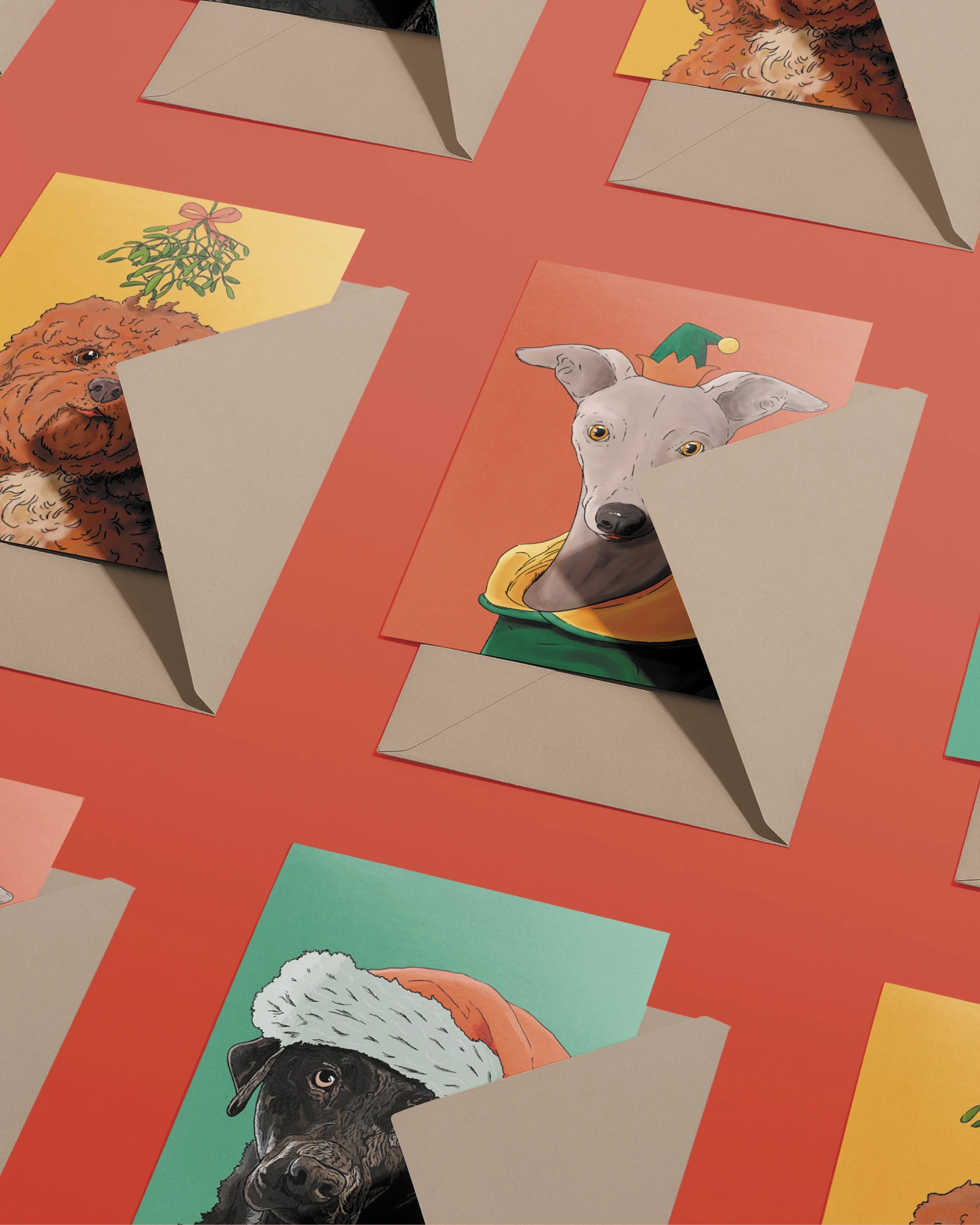 3 x A6 Dog Christmas Cards, bright digital illustrations including a Whippet in a green & red elf hat! Copies tucked into brown envelopes, set on a flat red background.