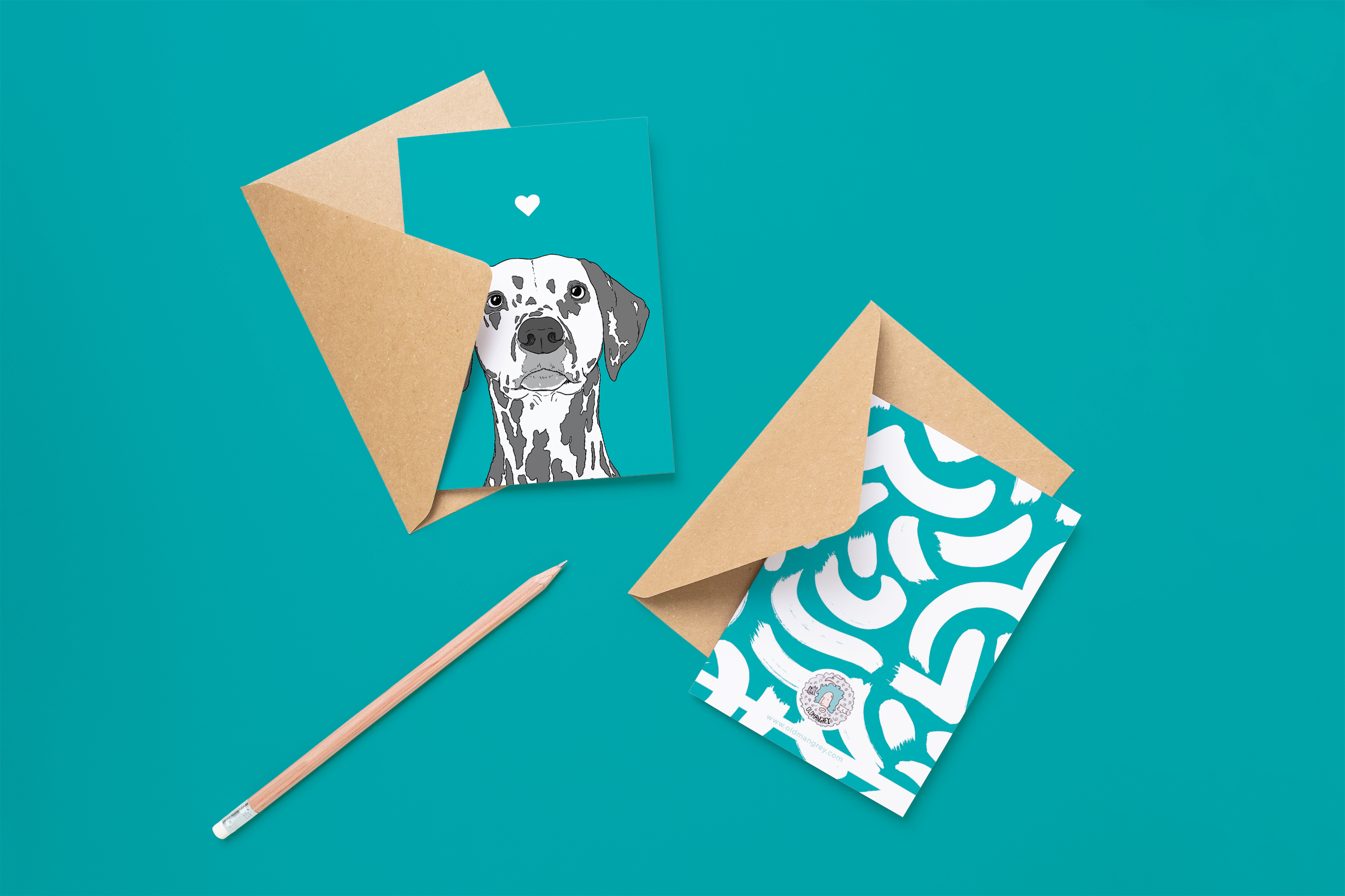 Two cards on brown envelopes, one face up one down. The card and image have a teal blue coloured background, with a black & white digital illustration of the head & shoulders of a Dalmatian dog.