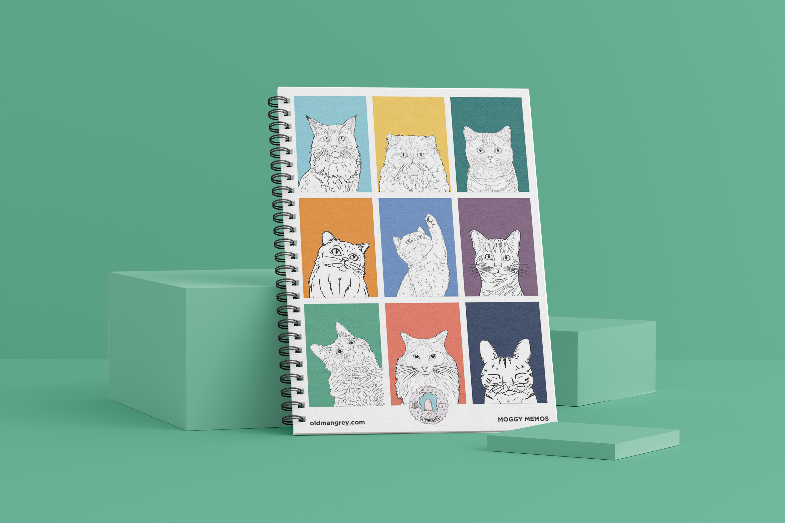 My A5 Moggy Memos wire bound notebook against a mint geen backdrop. It has 9 brightly coloured boxes each with a black & white digital illustration of the head & shoulders of different cat breeds.