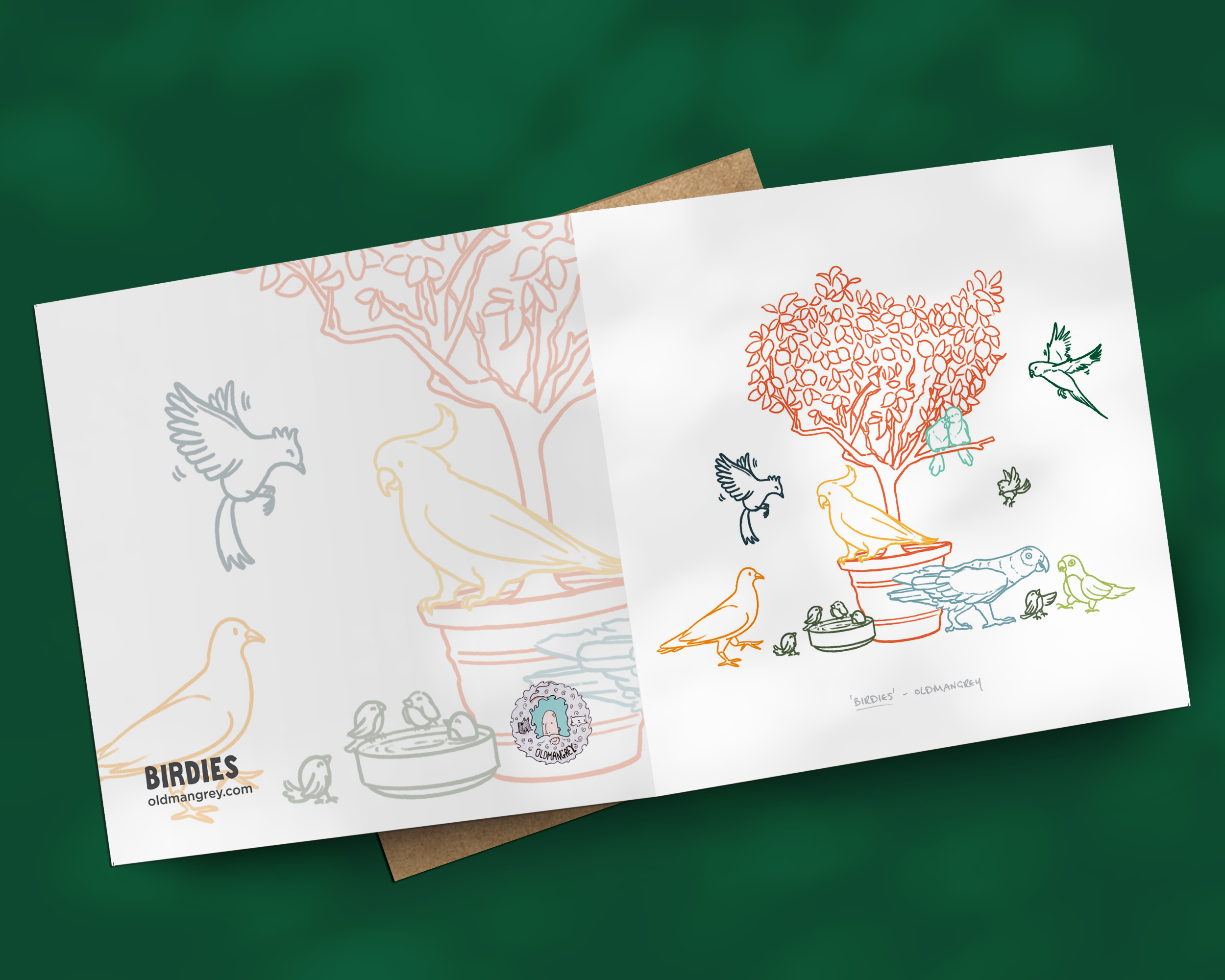 A square greetings card opened out flat, with a colourful digital illustration of birds on & around a small tree, an abstract version printed on the reverse. The image has a deep green background.