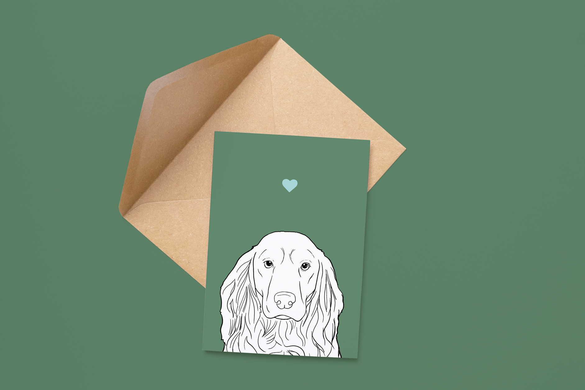 An A6 greetings card on a brown envelope. The card & image have a green background, with a black & white digital illustration of the head & shoulders of a Cocker Spaniel dog.