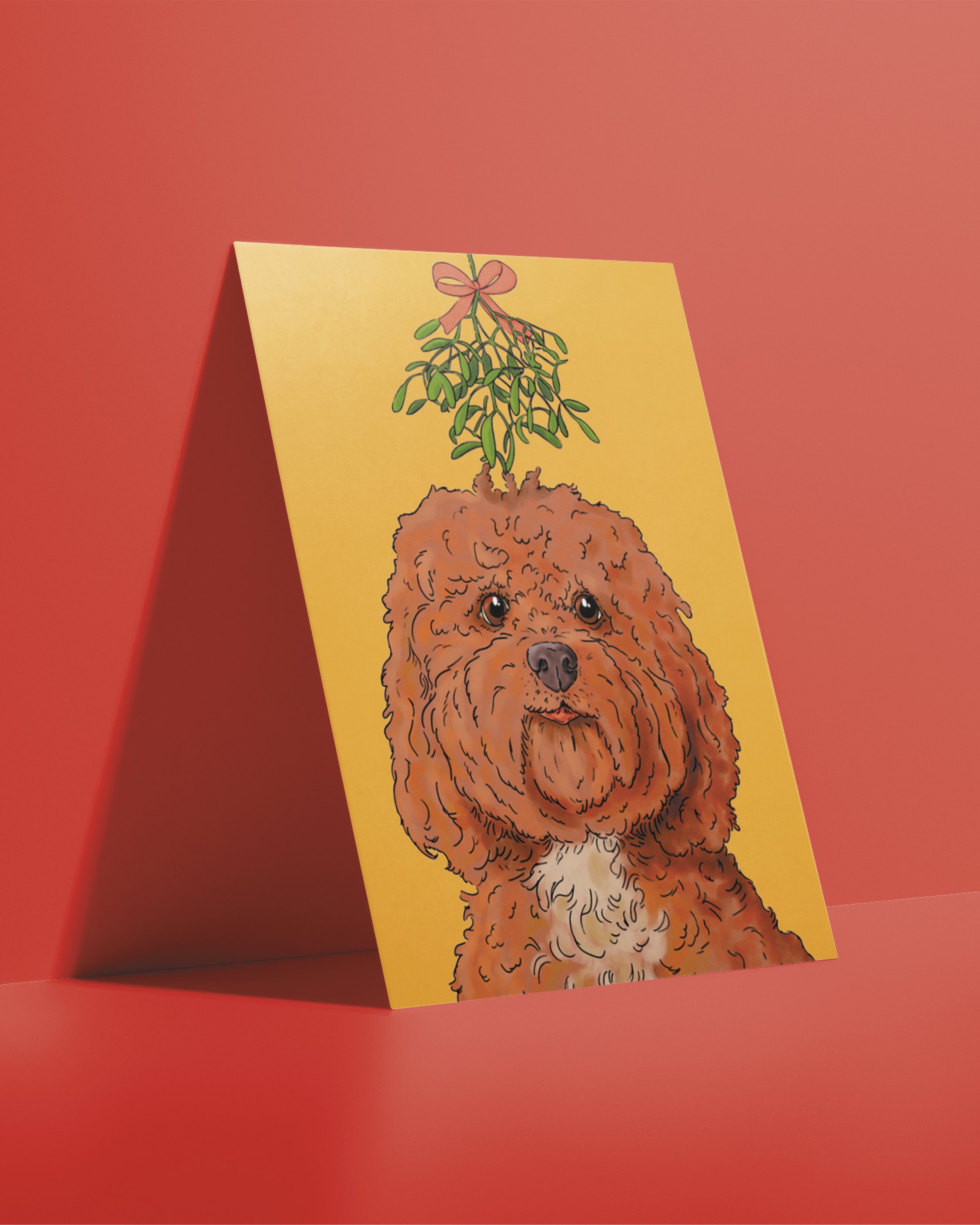 A6 Dog Christmas Card, bright digital illustration of a brown Cockapoo dog in under the mistletoe! Set on a flat yellow gold background.