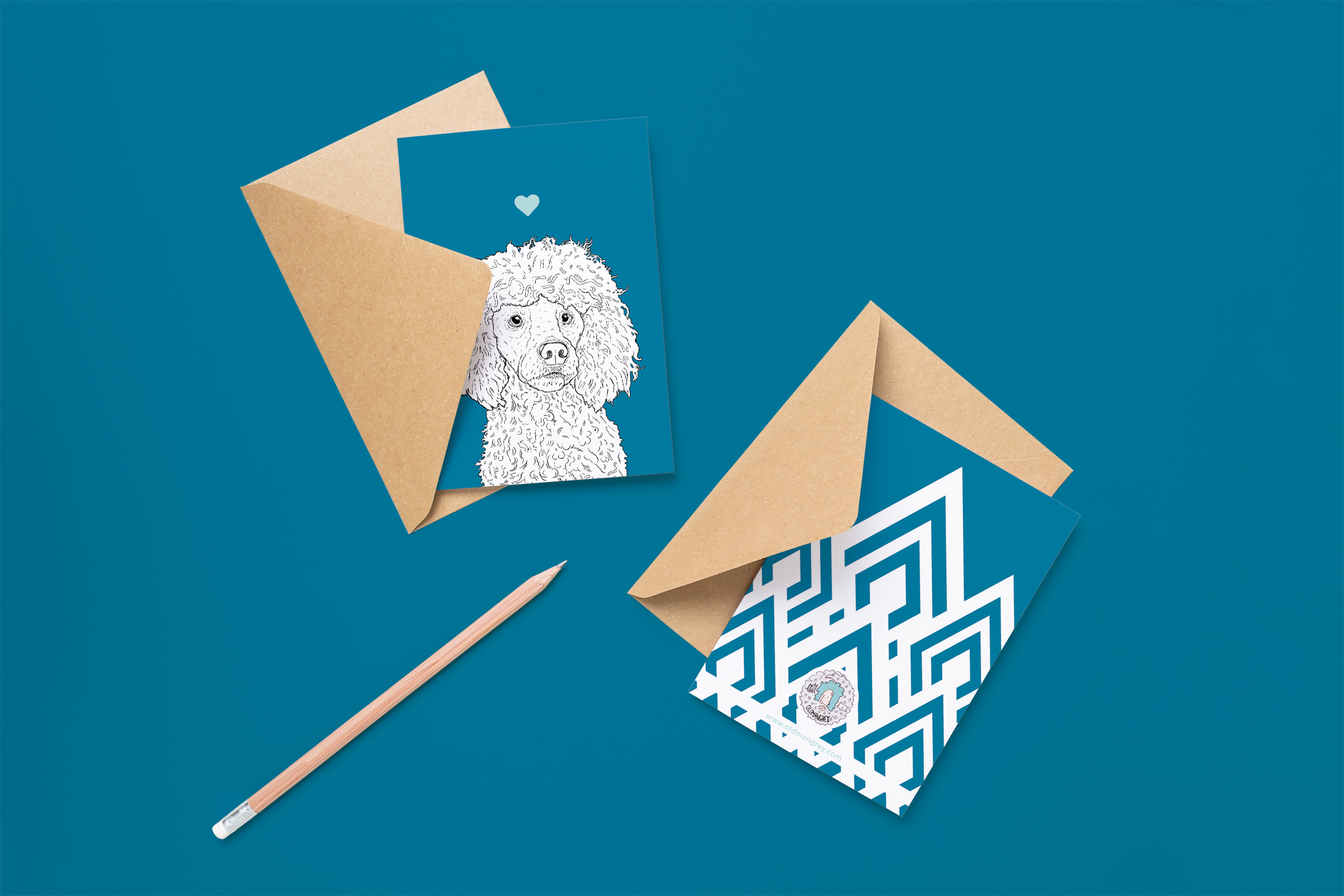 Two cards on brown envelopes, one face up one down. The card and image have a royal blue coloured background, with a black & white digital illustration of the head & shoulders of a Poodle dog.