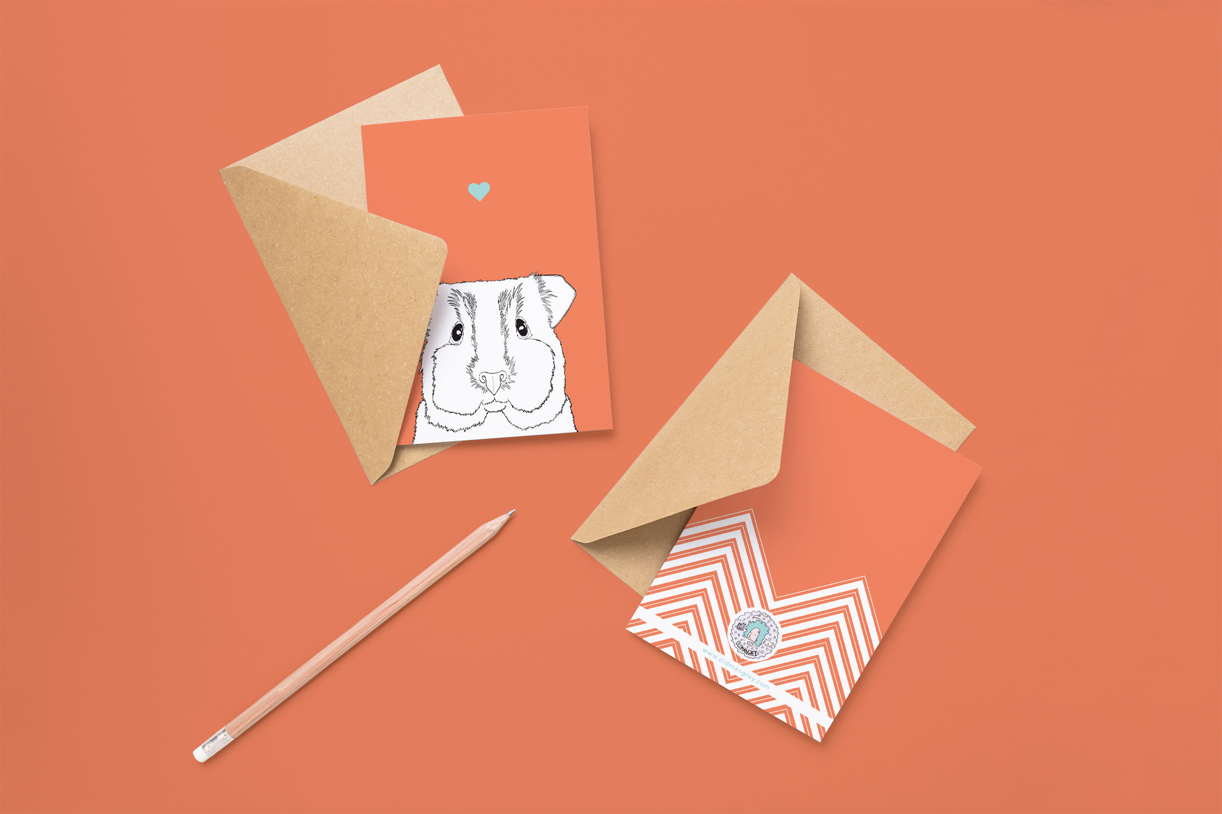 Two cards on brown envelopes, one face up one down. The card and image have a red coloured background, with a black & white digital illustration of the head & shoulders of a Guinea Pig.
