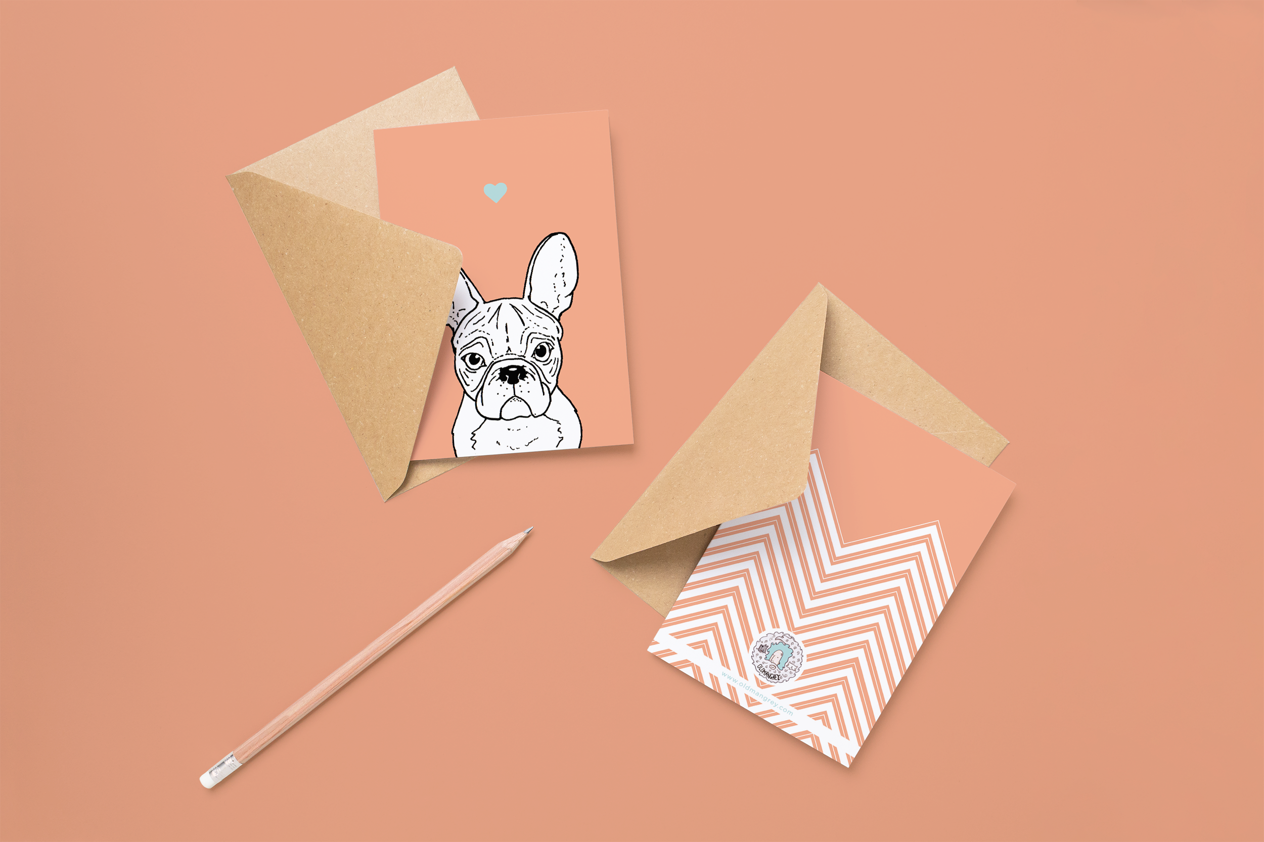 Two cards on brown envelopes, one face up one down. The card and image have a pink coloured background, with a black & white digital illustration of the head & shoulders of a Frenchie dog.