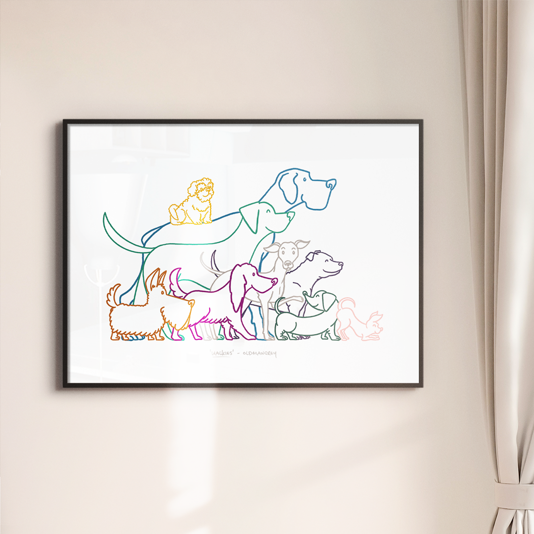 An A3 print in a thin dark frame on a white wall with soft light. The print has a colourful digital illustration of  9 dogs all ready to go walkies!