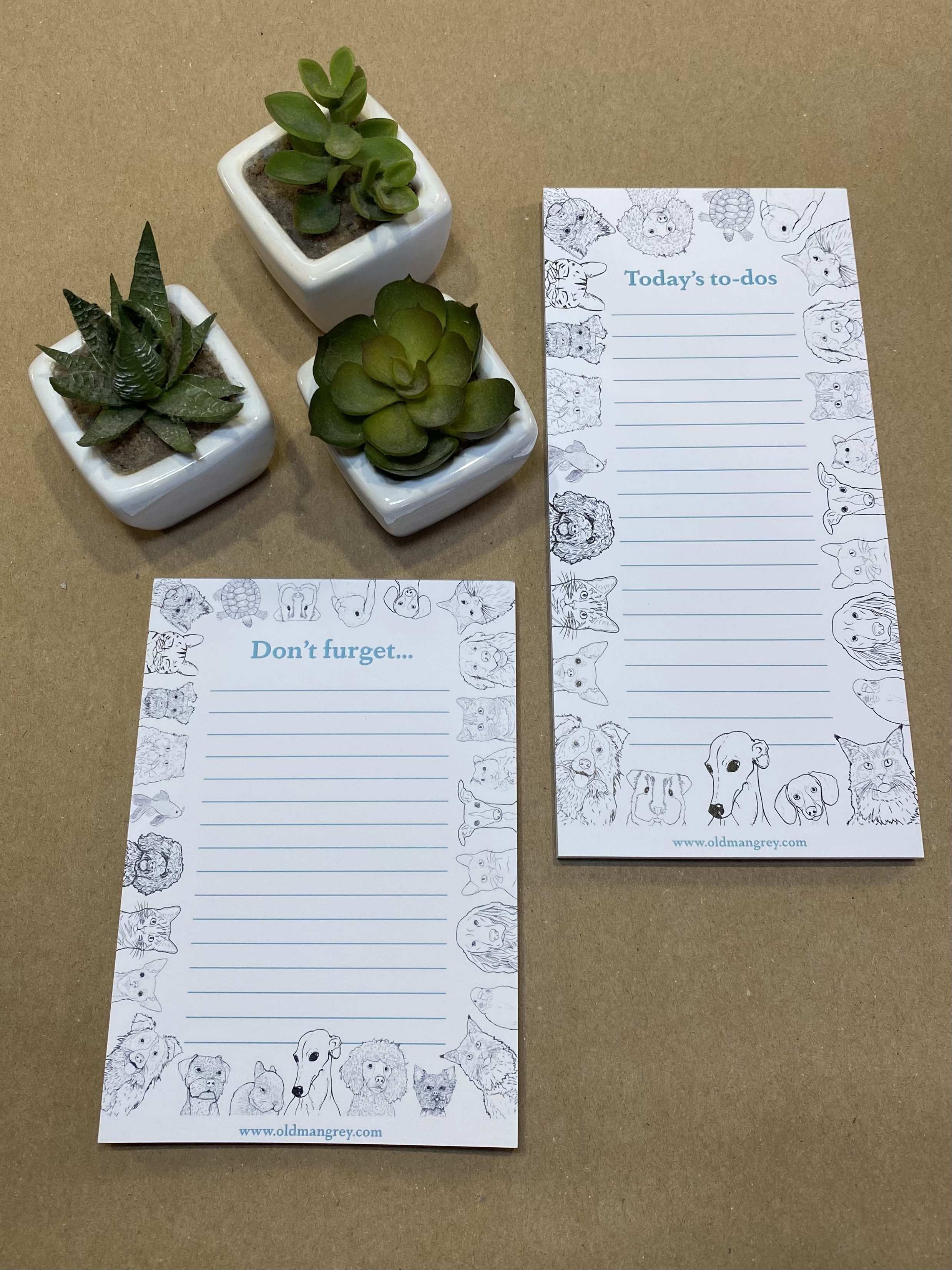 A6 memo pad titled 'Don't Furget' with a black & white border of digitally illustrated pets! Next to a longer pad in the same style, titled Today's To Do. 3 mini succulent plants at the top.