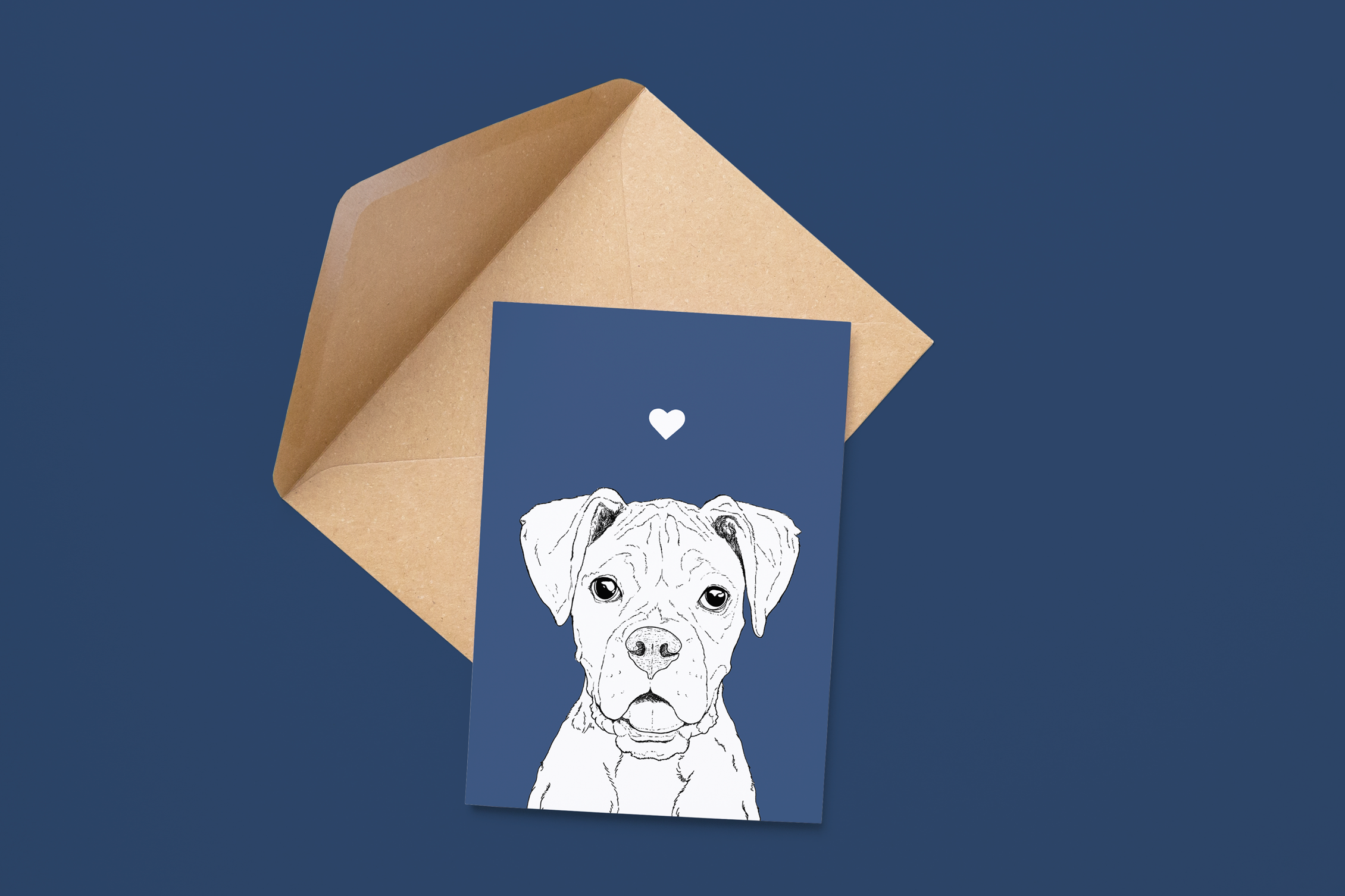 An A6 greetings card on a brown envelope. The card & image have a deep blue background, with a black & white digital illustration of the head & shoulders of a Boxer dog.