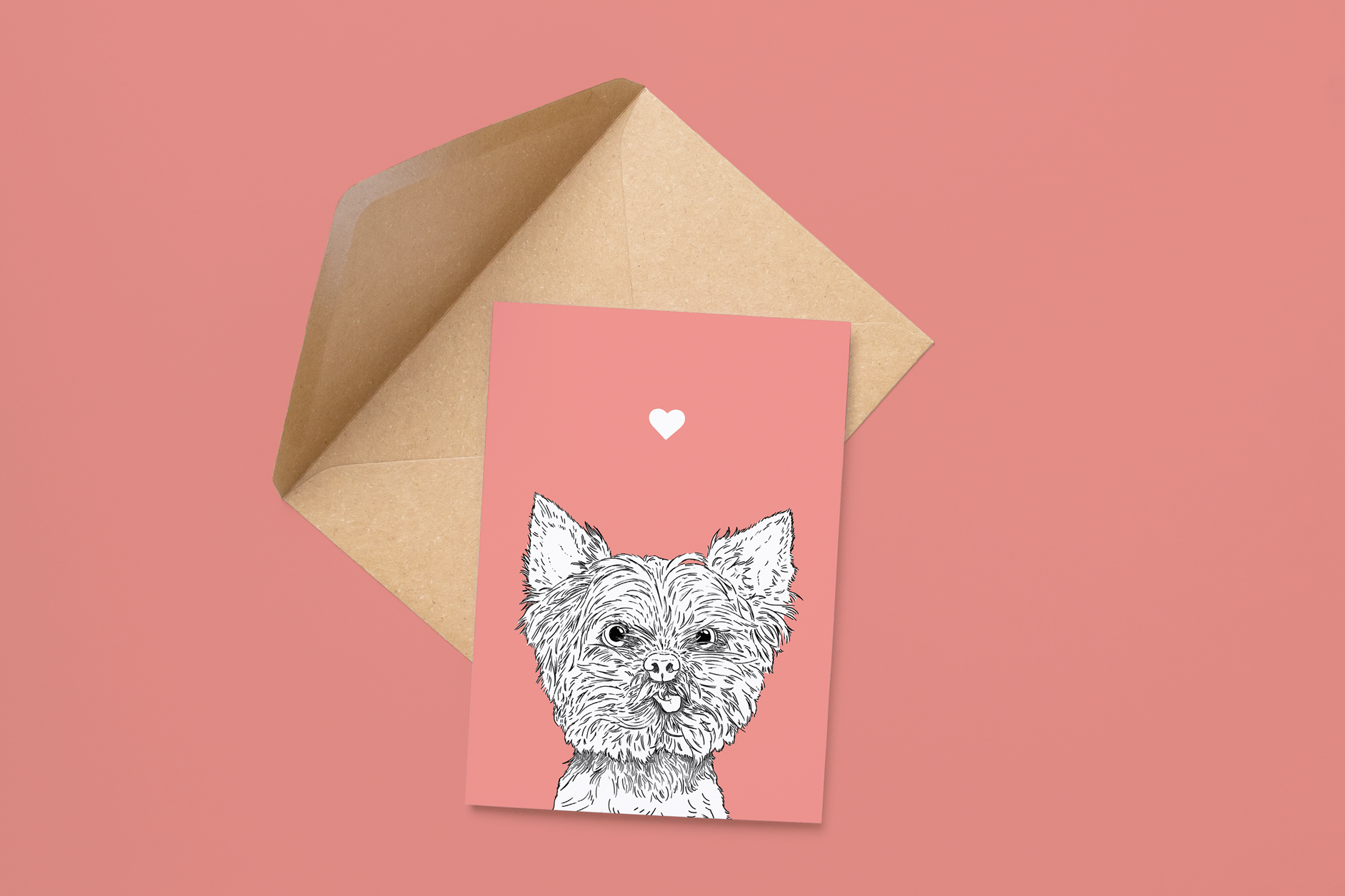 An A6 greetings card on a brown envelope. The card & image have a pale pink background, with a black & white digital illustration of the head & shoulders of a Yorkie dog.