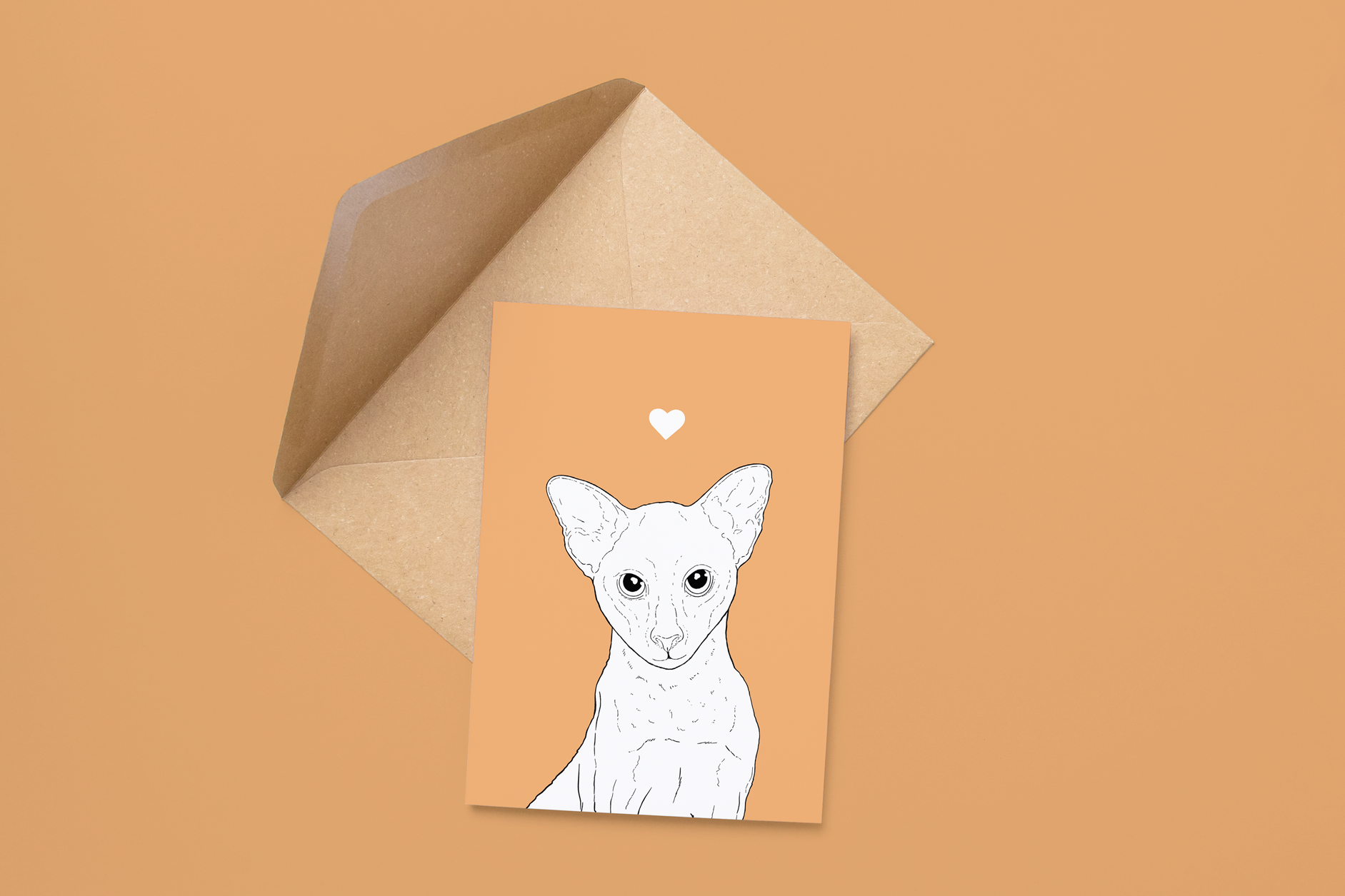 An A6 greetings card on a brown envelope. The card & image have a soft orange background, with a black & white digital illustration of the head & shoulders of an Oriental cat.