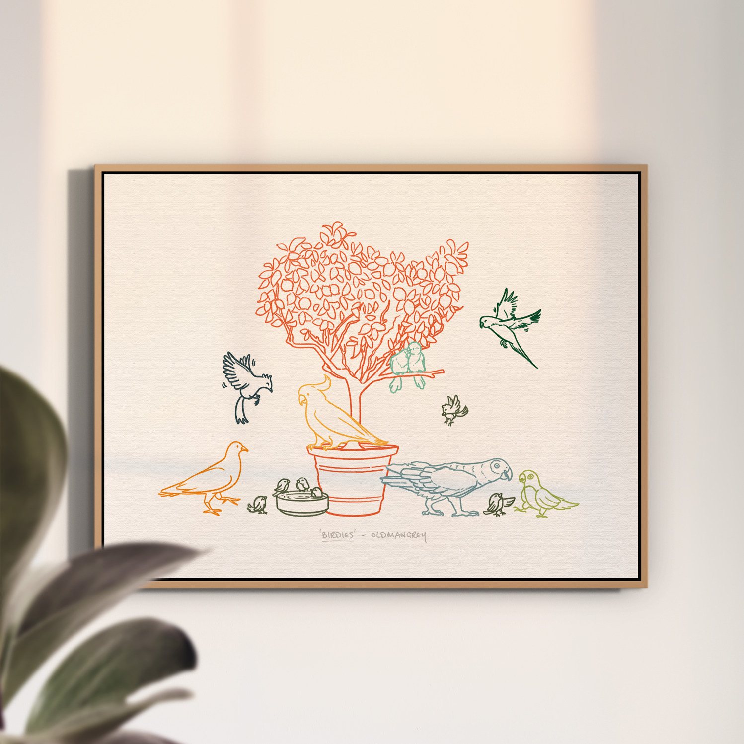 An A3 print in a thin wooden frame on a white wall with soft light. The print has a colourful digital illustration of birds on & around a small tree.