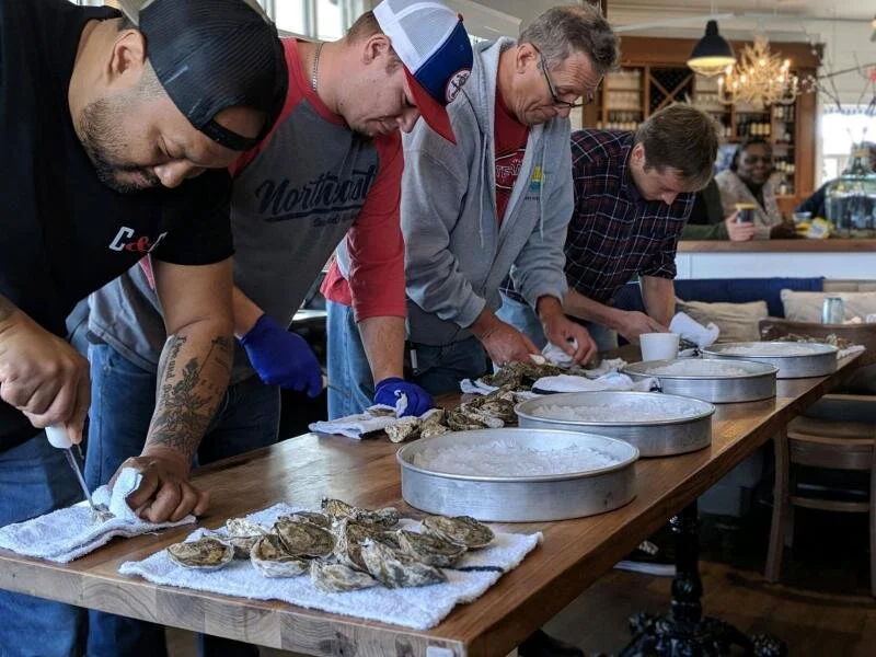 SoDel employees competing in an oyster shuck-off are (l-r) Maurice Catlett, winner; Charles Armstrong; Chris Lippa; and Brian Hutchinson. SUBMITTED PHOTOS