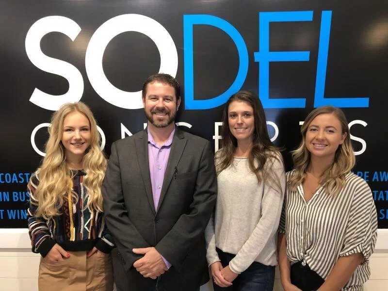 Three SoDel Concepts employees recently won prizes from Bouchaine Vineyards, owned by Delaware residents Gerret and Tatiana Copeland. Mike Zygmonski, the company’s wine director, is pictured witht he winners. Shown are (l-r) Viktoria Kuleshova, Zygm…