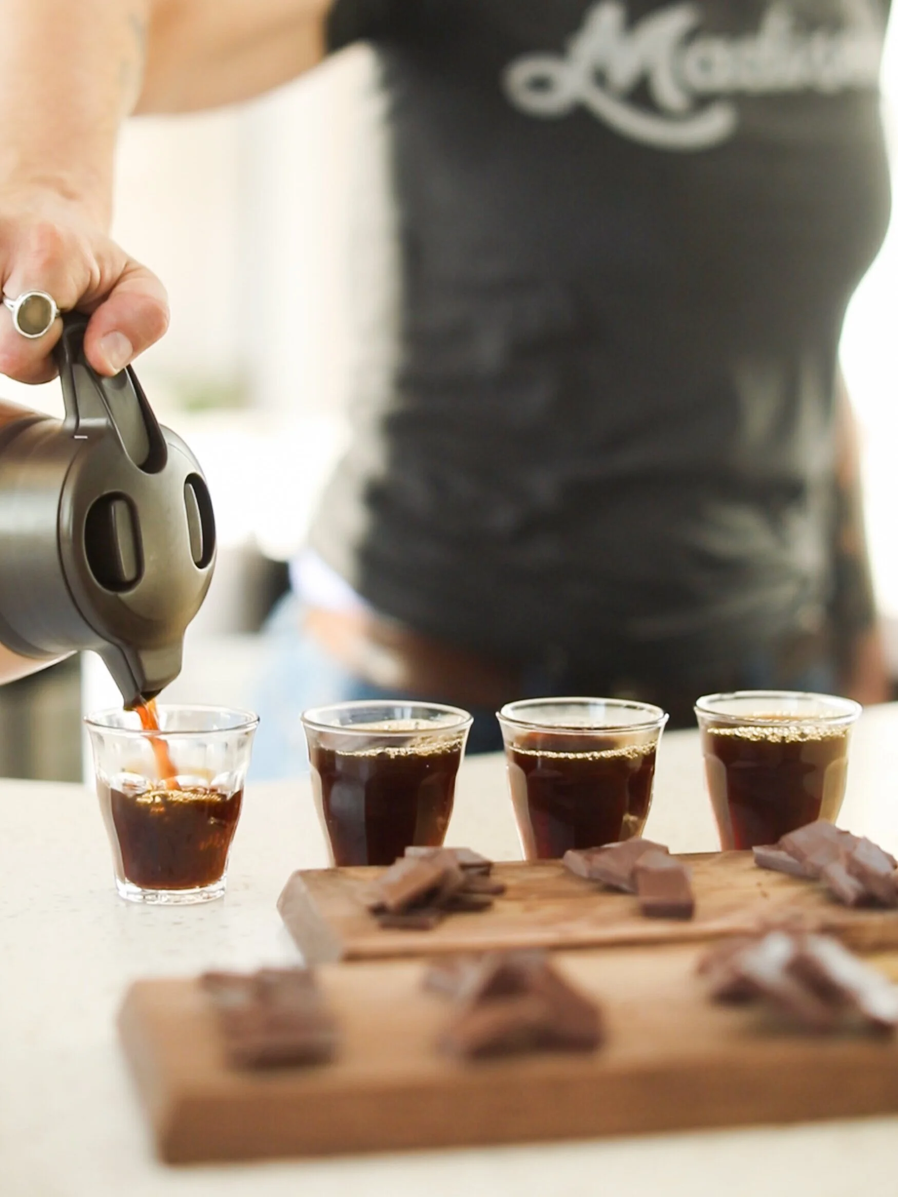 barista pours four coffees