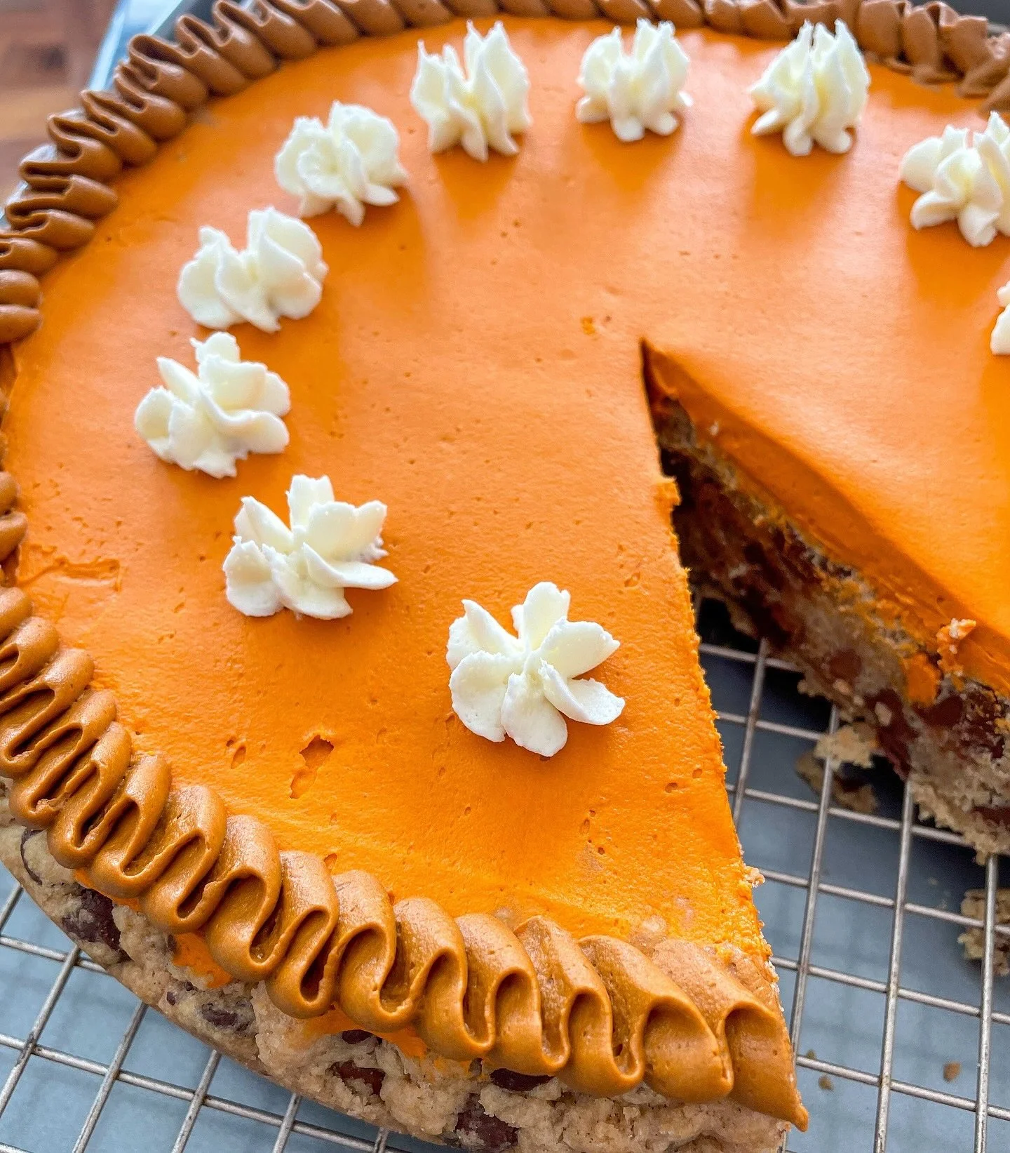 Get your orders in for our delicious 10&rdquo; whole chocolate chip cookie cakes, perfect for Thanksgiving! 🍪🦃

Made with our signature cookie dough and topped with vanilla buttercream to resemble a pumpkin pie. No pumpkin flavor, just pure chocola