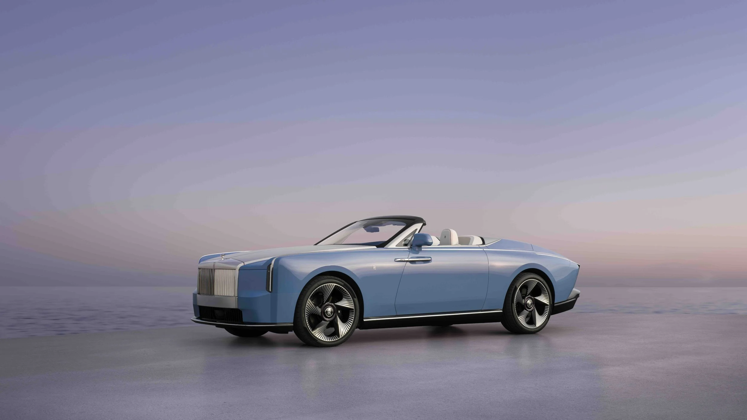 A sleek, modern electric convertible car with a light blue exterior parked on a flat surface near a body of water, under a clear sky during sunset.