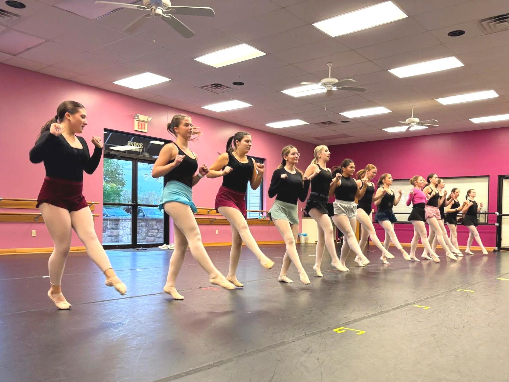 A line of teen ballet dancers in dance class at MKDS.
