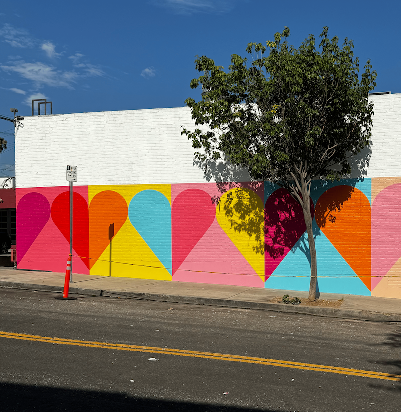 A mural of hearts on a streetwall