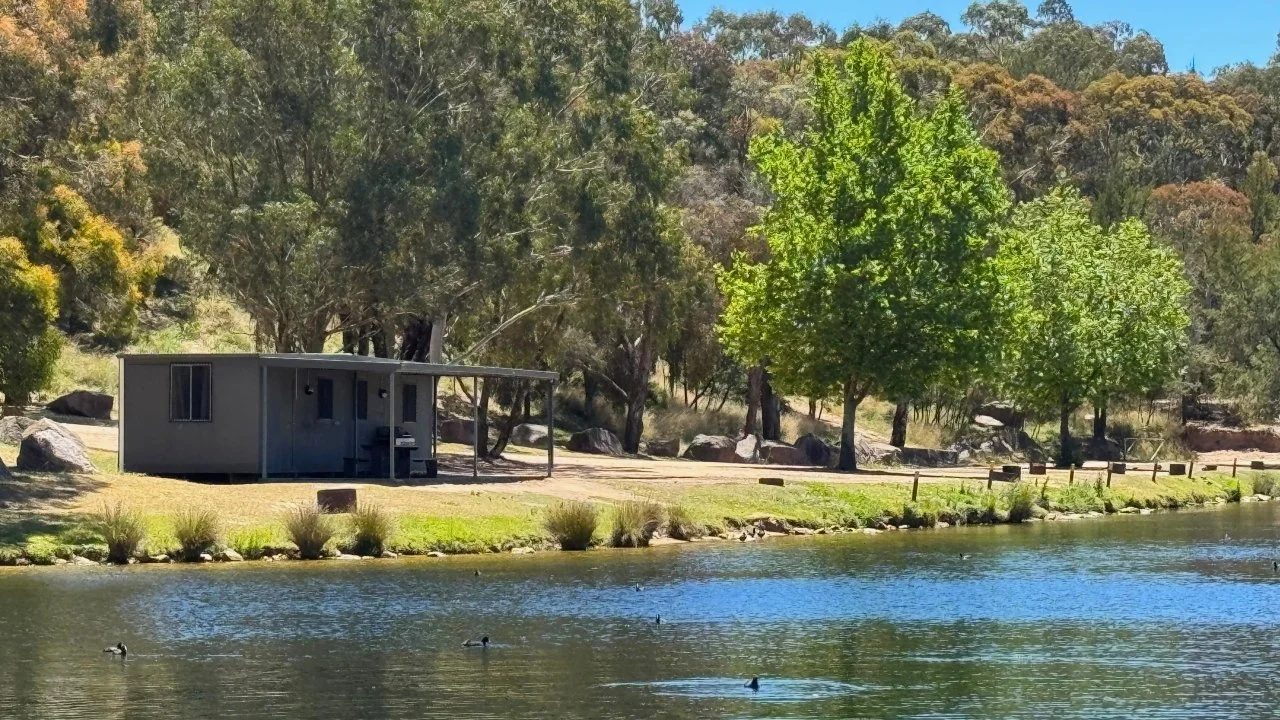 The Ski Lodge Cabin nestled on the waterfront at Lake Lyell Recreation Park