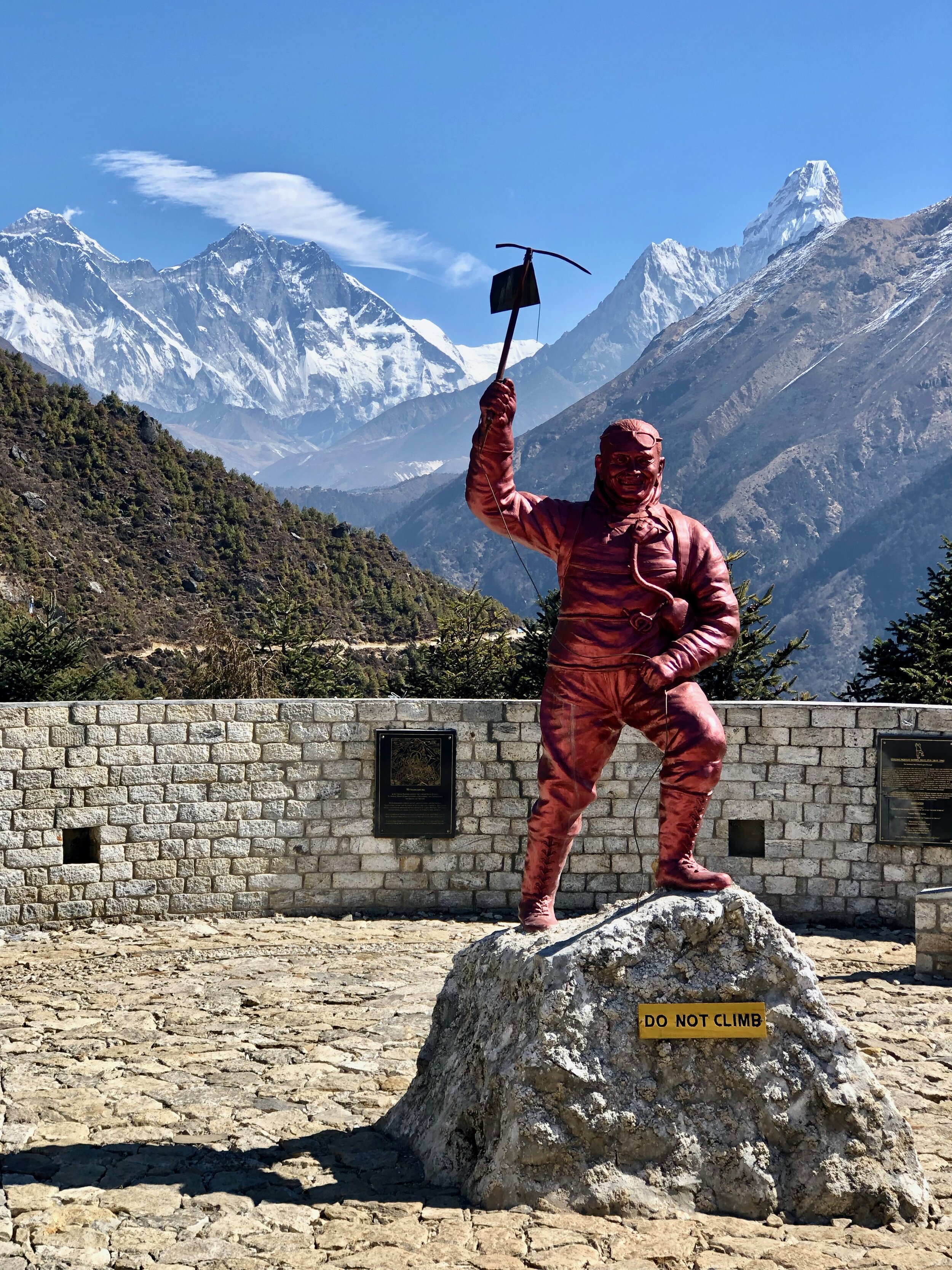 Statue of Tenzing Norgay Sherpa, with Mt. Everest in the background, in Namche Bazaar.