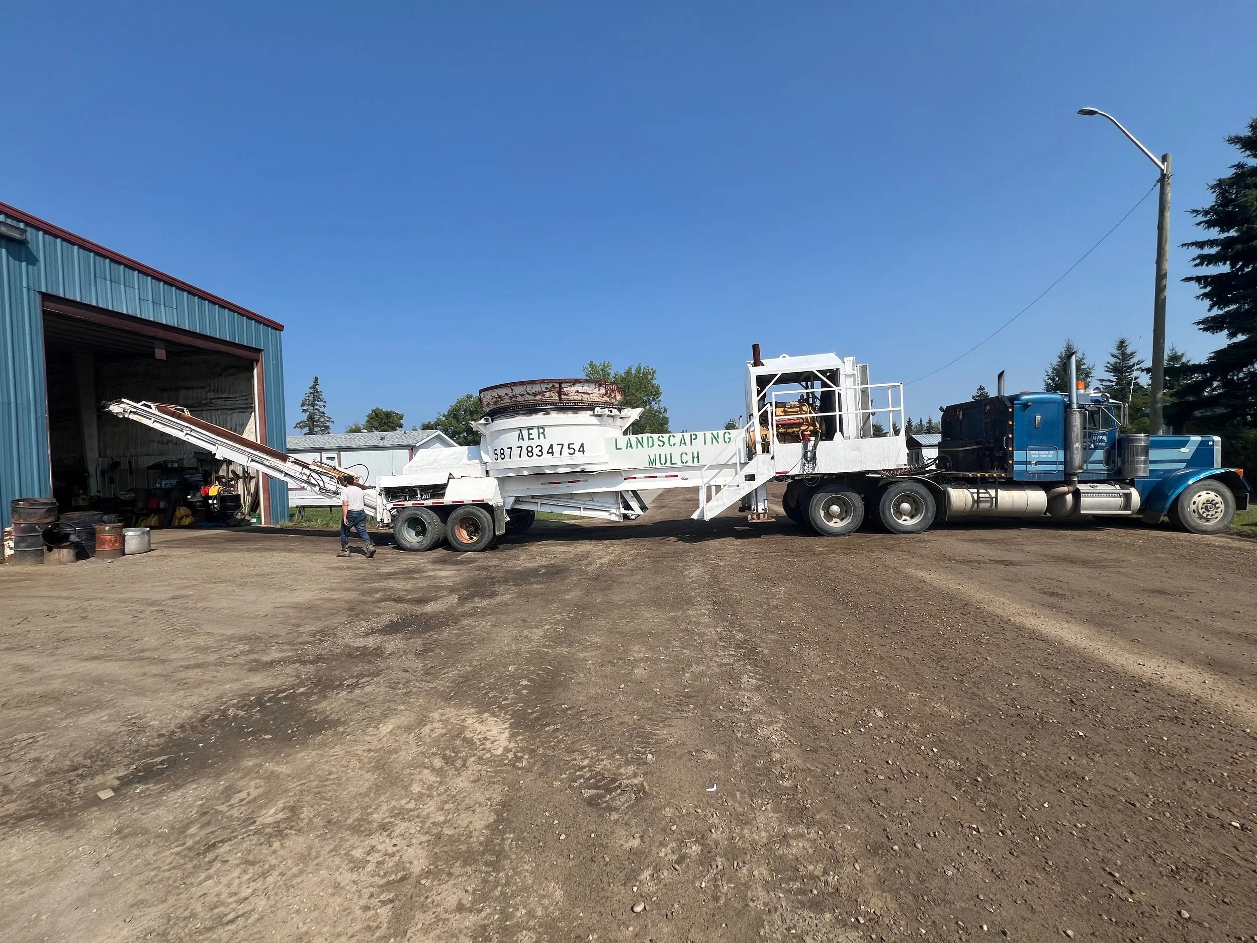 Our Tub Grinder Being Delivered by Highway 43 Towing and Serviced by Mayerthorpe Welding & Supplies