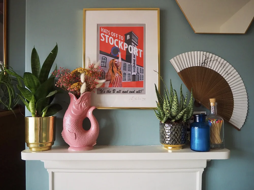 A guggle jug from Oliver Bonas adds a touch of fun to the bedroom fireplace
