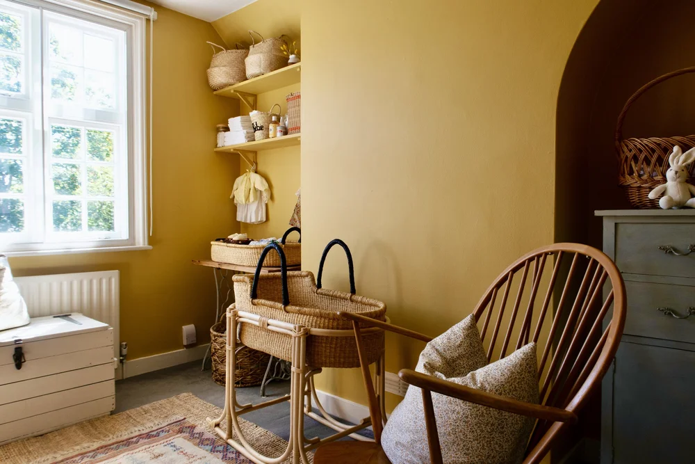The nursery is painted in Farrow &amp; Ball’s Sudbury Yellow