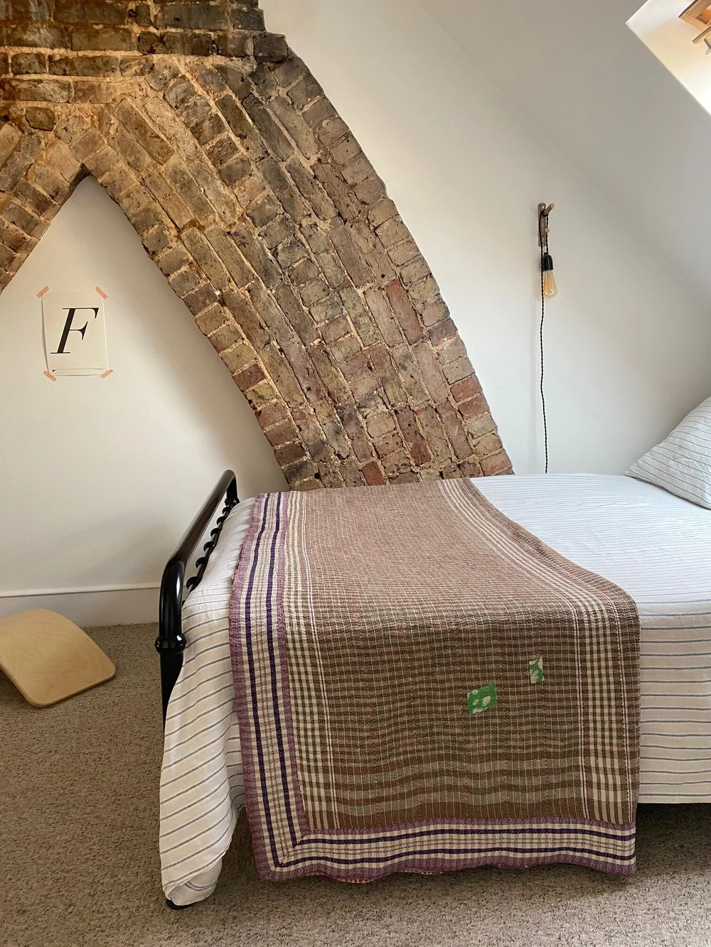 A child's bedroom in the loft conversion features exposed brickwork