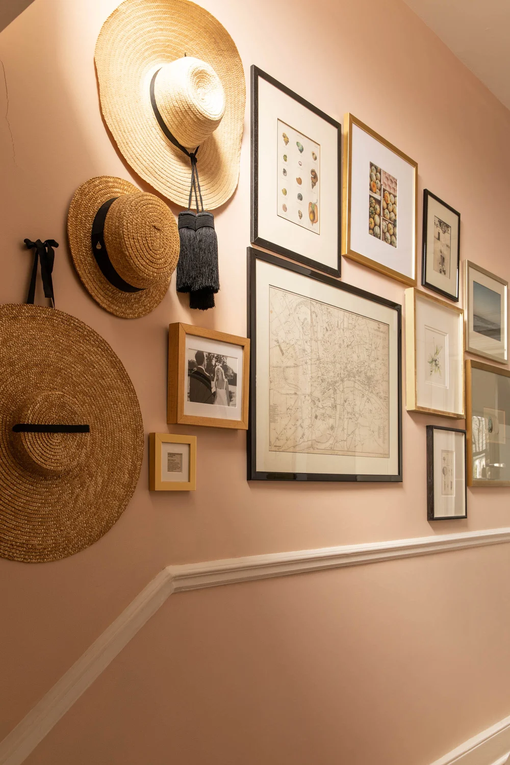 Gallery wall with straw hats and frames