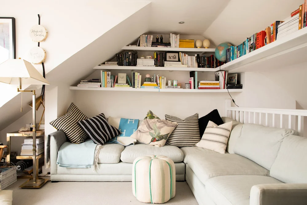 The mezzanine seating area looks out on to a balcony. The footstool is by Francesca Gentilli