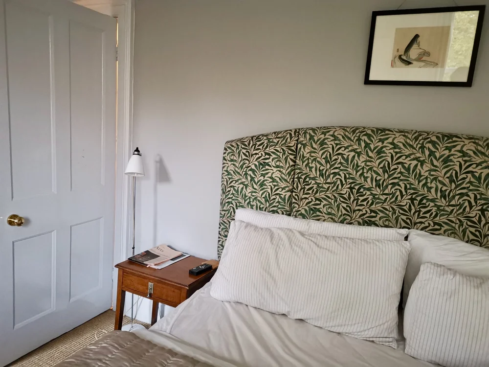 The headboard is from The Chaise Longue Company and covered in William Morris fabric from eBay
