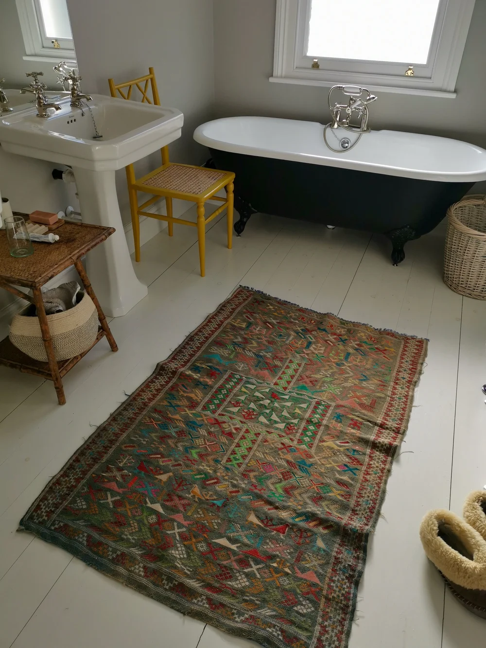 The yellow bathroom chair is from Ceraudo; the rug is from Cart House